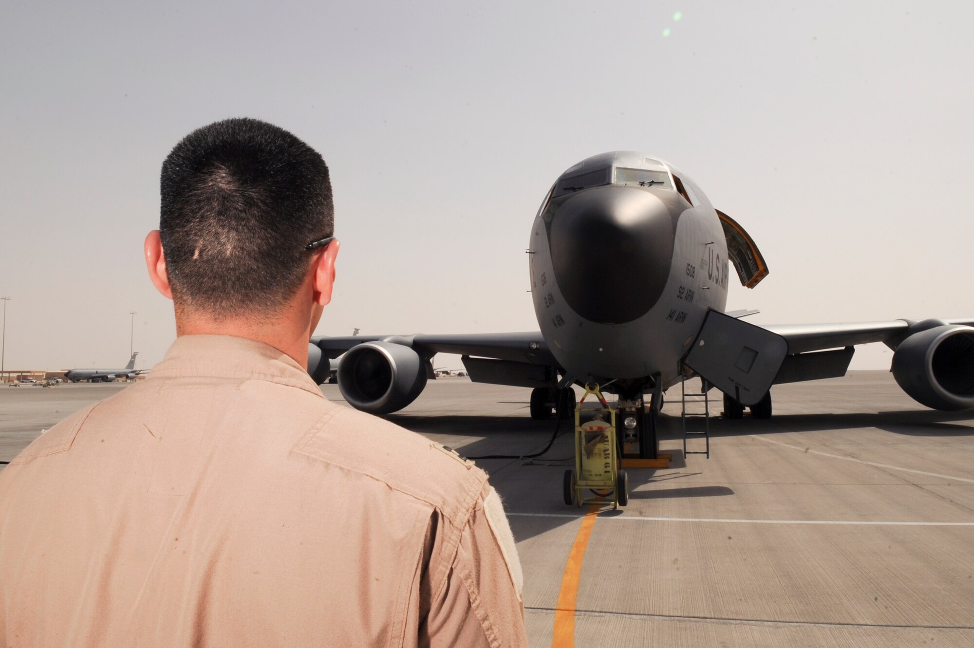 Captain Andrew McLay, a pilot with the 340th Expeditionary Air Refueling Squadron, does a walk-around to check out the overall exterior of a KC-135R Stratotanker prior to boarding the aircraft for preflight checks, March 5, 2009, in an undisclosed location in Southwest Asia.  Captain McLay is native to Evergreen Colo. and is deployed from Royal Air Force, Mildenhall, England in support of Operations Iraqi and Enduring Freedom and Combined Joint Task Force - Horn of Africa.  (U.S. Air Force Photo by Staff Sgt. Joshua Garcia/released)