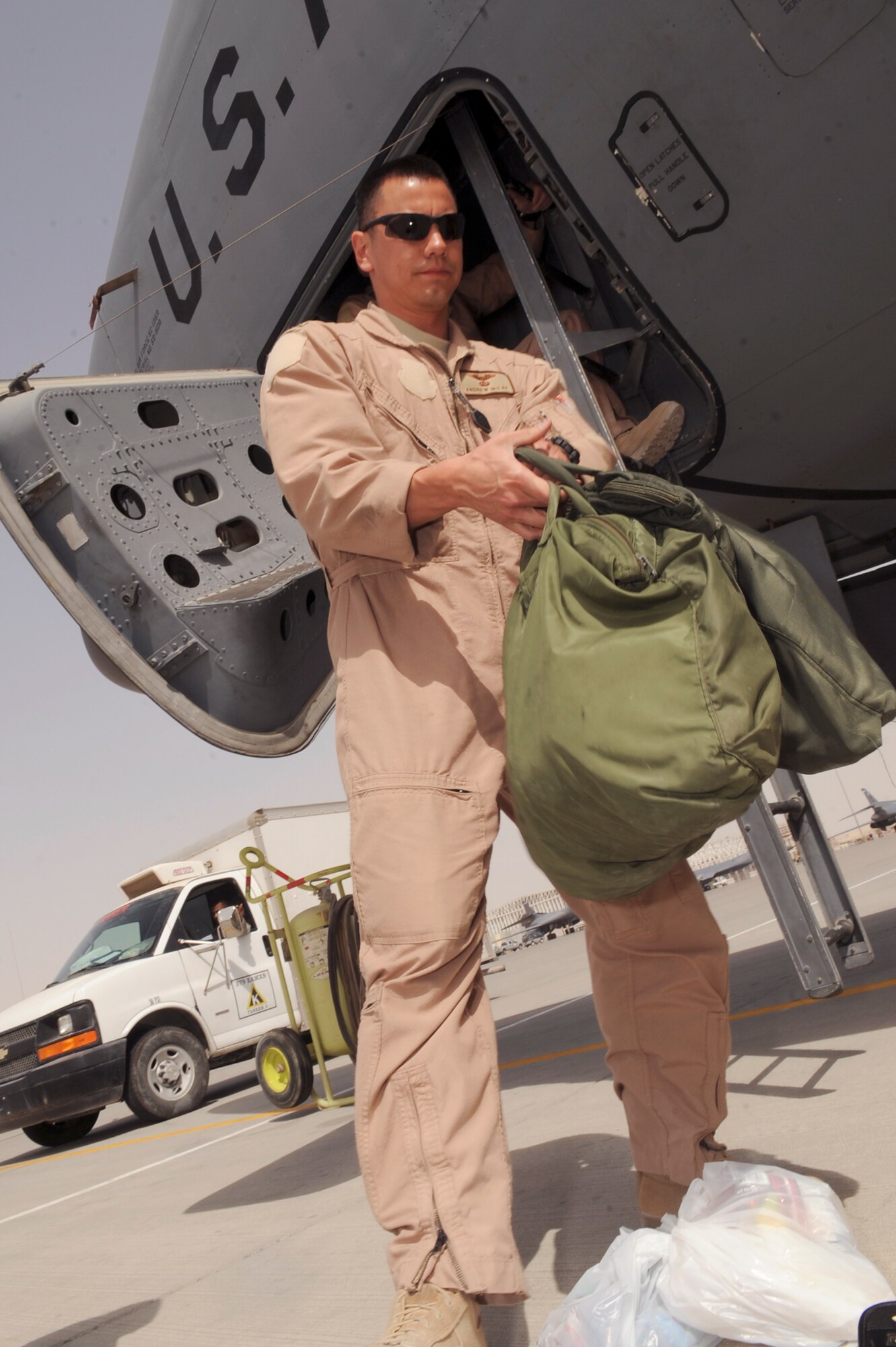 Captain Andrew McLay, a pilot with the 340th Expeditionary Air Refueling Squadron, prepares to hand up his gear into a KC-135R Stratotanker before boarding for another in-flight refueling mission, March 5, 2009, in an undisclosed location in Southwest Asia.  Captain McLay is native to Evergreen Colo. and is deployed from Royal Air Force, Mildenhall, England in support of Operations Iraqi and Enduring Freedom and Combined Joint Task Force - Horn of Africa.  (U.S. Air Force Photo by Staff Sgt. Joshua Garcia/released)