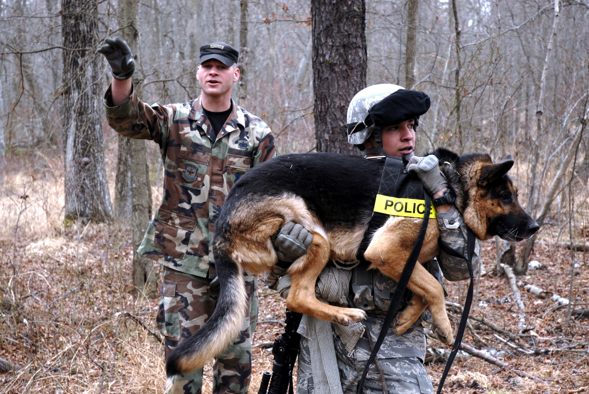 Canine handler instructor, Staff Sgt. Brennon Pierce (left), directs students in the Air Force Phoenix Warrior Training Course through a combat first aid scenario on a Fort Dix, N.J., range on Feb. 28, 2009.  The course, taught by the U.S. Air Force Expeditionary Center's 421st Combat Training Squadron also at Fort Dix, N.J., prepares security forces Airmen for upcoming deployments.  (U.S. Air Force Photo/Staff Sgt. Paul R. Evans)