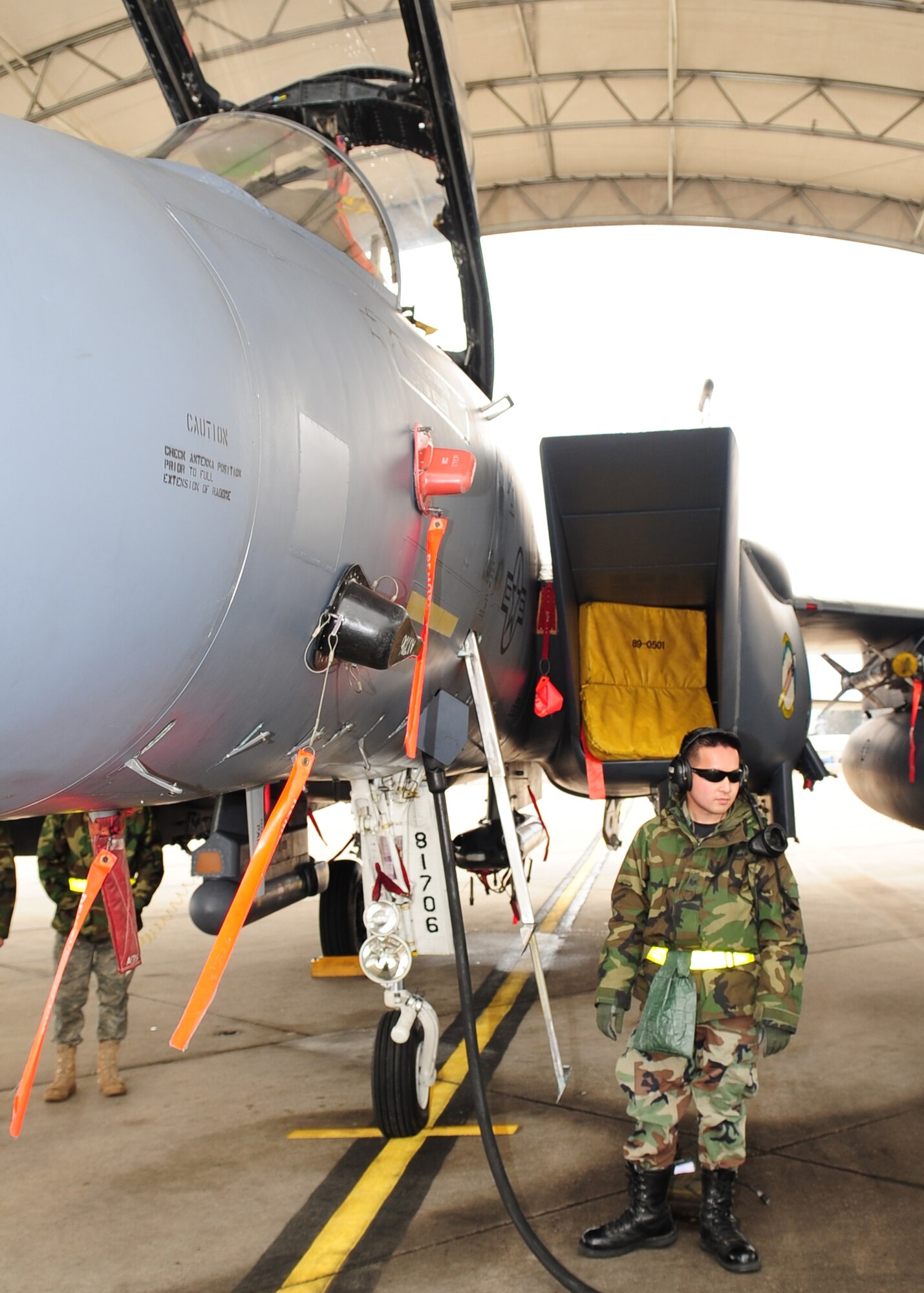 Staff Sgt. Hai Ho, 336th Aircraft Maintenance Squadron, waits for the generator to shut down before disconnecting the F-15E Strike Eagle after completion of a power-on test under a new flightline shelter at Seymour Johnson Air Force Base N.C., March 2. The shelters main purpose is to prevent sun damage and minimize the amount of rain that reaches the aging aircraft. (U.S. Air Force Photo by Airman 1st Class Rae A. Perry)