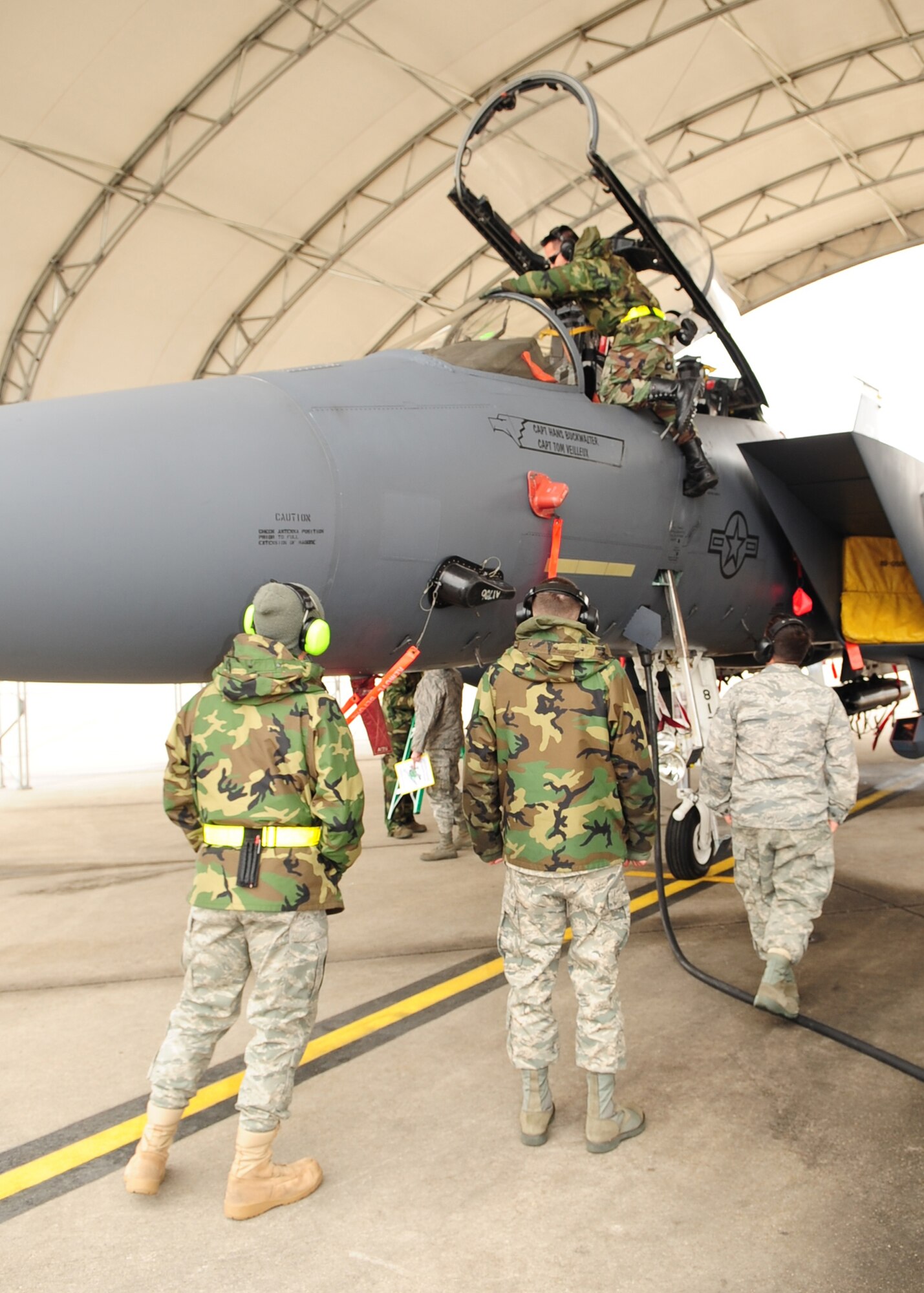 Senior Airmen Tom McGuire, Corey Prater, Jon Meyers and Staff Sgt. Hai Ho, 336th Aircraft Maintenance Squadron, prepare to conduct a power-on test under a flight line shelter at Seymour Johnson Air Force Base N.C., March 2. The shelters were designed to minimize weather damage to the aircraft. (U.S. Air Force Photo by Airman 1st Class Rae A. Perry)
 
