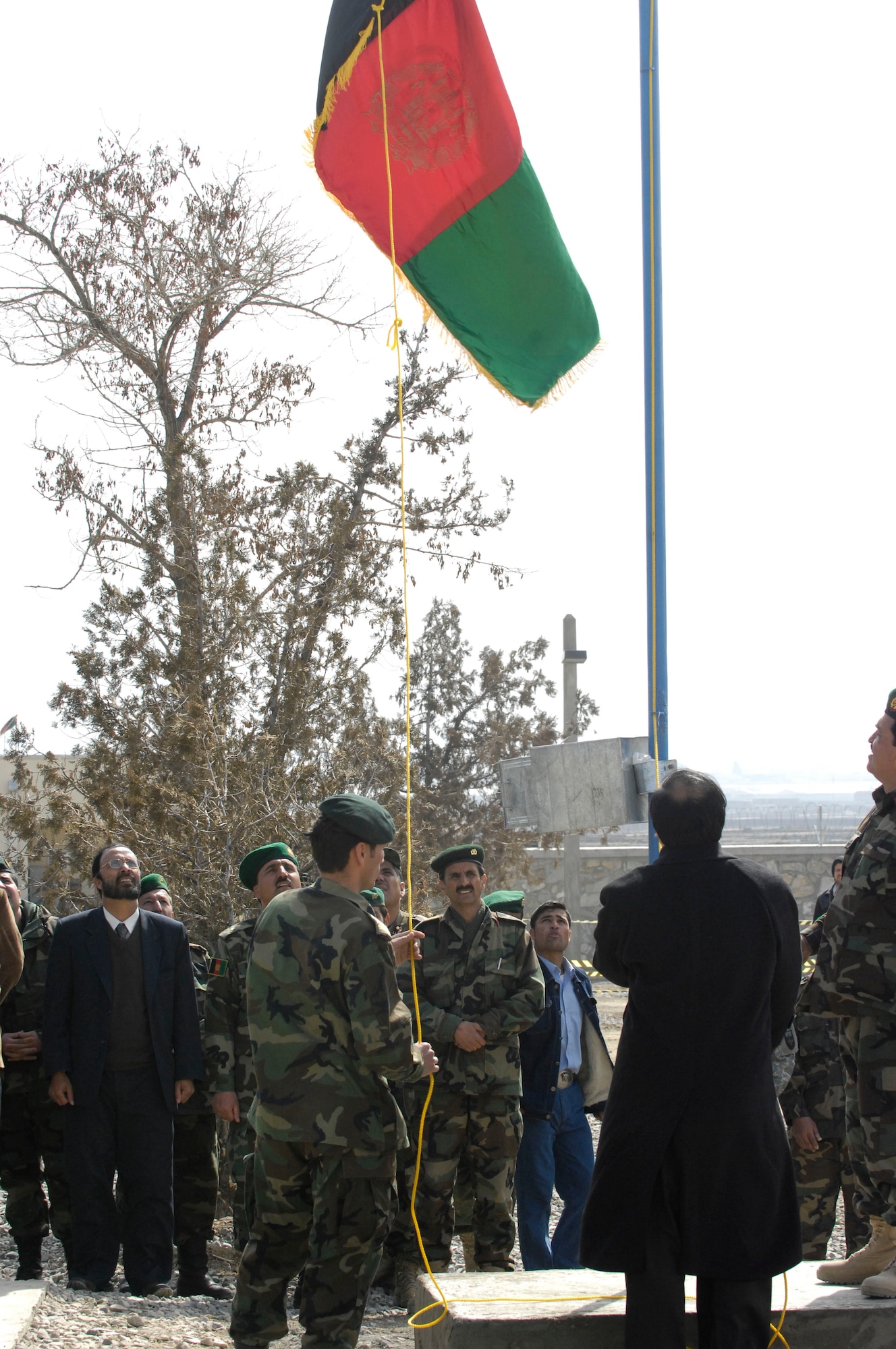 Members of the Afghanistan National Army and Afghan Assistant Defense Minister Lt. Gen. Jawhari, chief of acquisition, technology and logistics, raise the Afghanistan flag for the first time Feb. 28 at the Khuja Rawash Class III Fuels Depot in Kabul. (U.S. Air Force photo/ Maj. Carie A. Parker)(Released)
