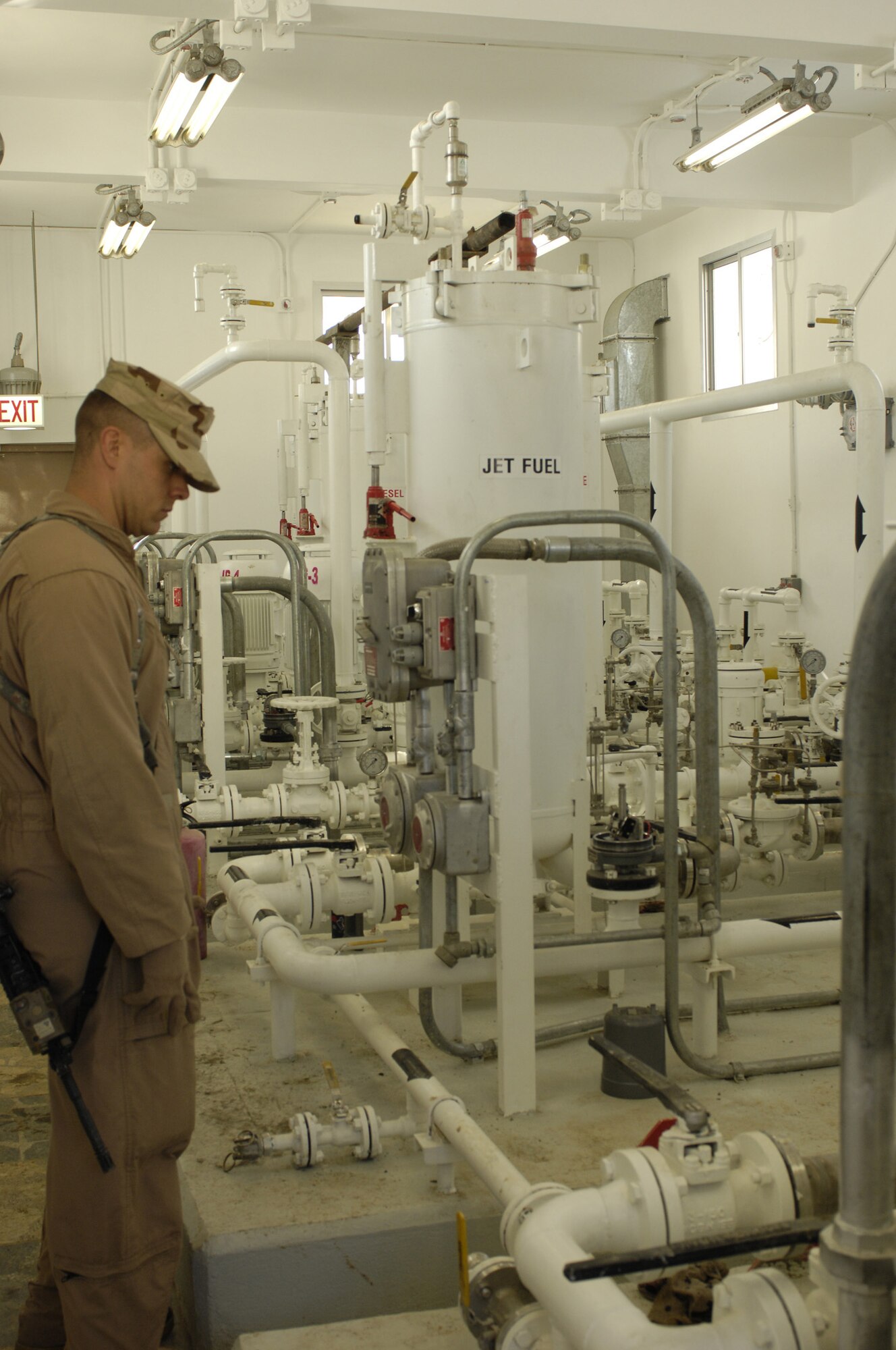 Staff Sgt Jason King, 755th Air Expeditionary Group, Logistics Embedded Training Team, Combined Security Transition Command - Afghanistan, checks valve configurations for a system set up in one of the Class III Fuels Depot pump houses. The new depot, inaugurated Feb. 28, boasts modern systems to determine fuel tank levels as well as temperature. Central controls also allow operators to accurately transfer fuel with the touch of a button. (U.S. Air Force photo/ Maj. Carie A. Parker)(Released) 

