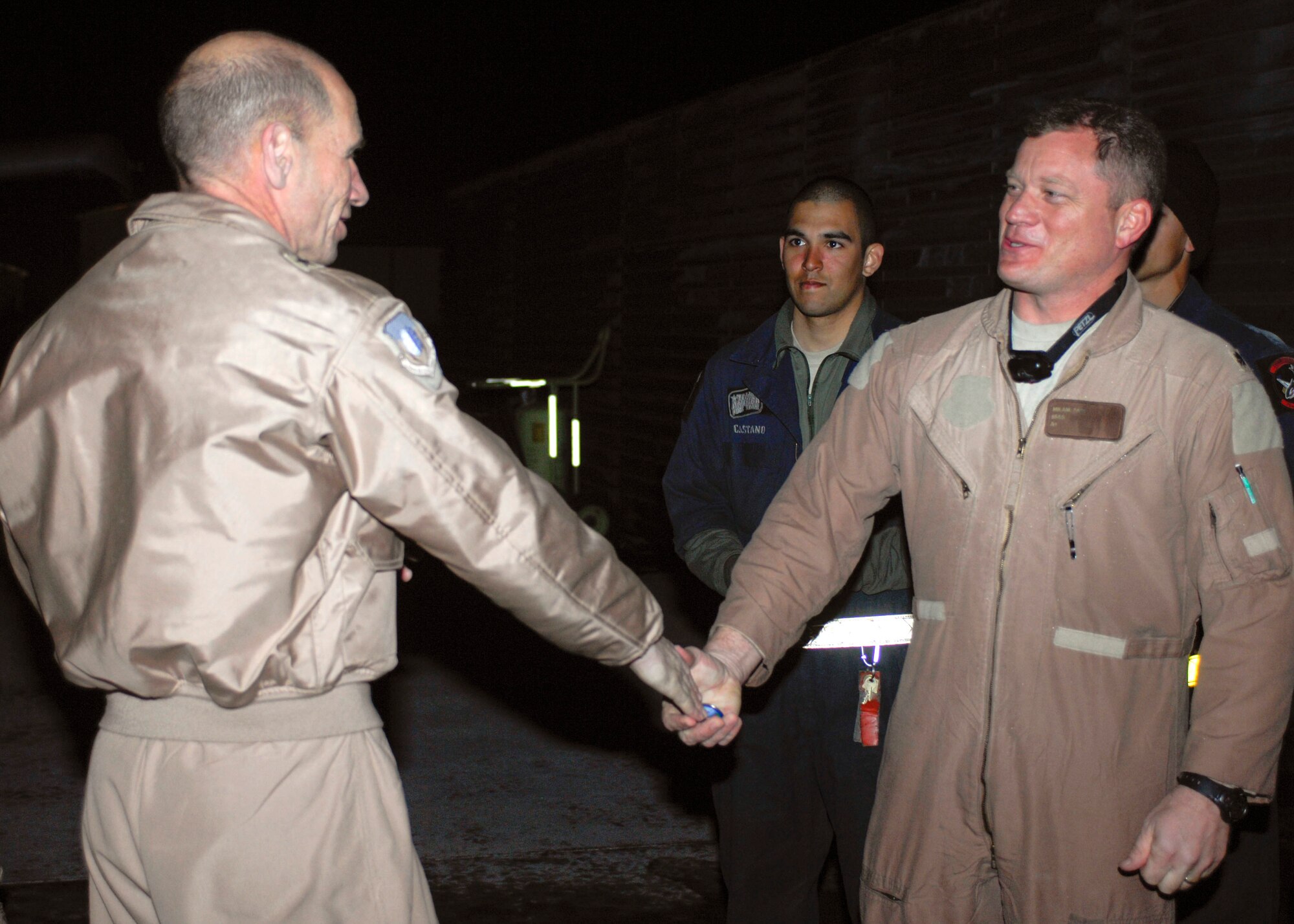 Brig. Gen. Mike Holmes, 455th Air Expeditionary Wing commander congratulates Lt. Col. Sam "Spam" Milam, 75th Expeditionary Fighter Squadron, Feb. 28 as he completed his 3,000 combat hours at Bagram Air Field, Afghanistan. This event occurred a week after the 75th EFS completed 10,000 combat flight hours. Colonel Milam is deployed from Moody Air Force Base, Ga. (U.S. Air Force photo/ Senior Airman Erik Cardenas)(Released)
