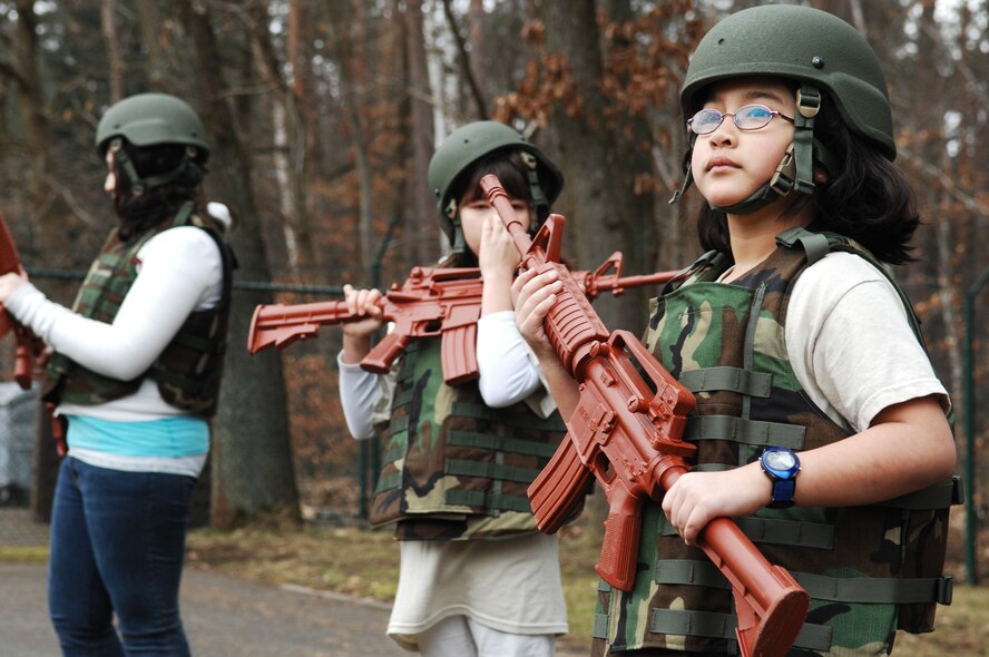 Ilamiel Nunez and other children learn defense techniques from the 569th U.S. Forces Police Squadron during the Kids 4 Kids monthly event Feb. 27, 2009, at Ramstein Air Base. K4K is a monthly program for children with a deployed parent with events designed to help children understand better what their parent's do while deployed. (U.S. Air Force photo by Senior Airman Amber Bressler)