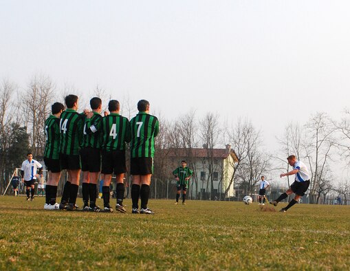 Aviano Futbol Club forward John Riley smashes the ball towards the goal during the AFC vs Avocati Pordenone match Feb. 28 in Sedrano. Riley's kick found the top right of the net, bringing the AFC to a 5-0 win over the AP. (U.S. Air Force photo by Staff Sgt. Justin Weaver)
