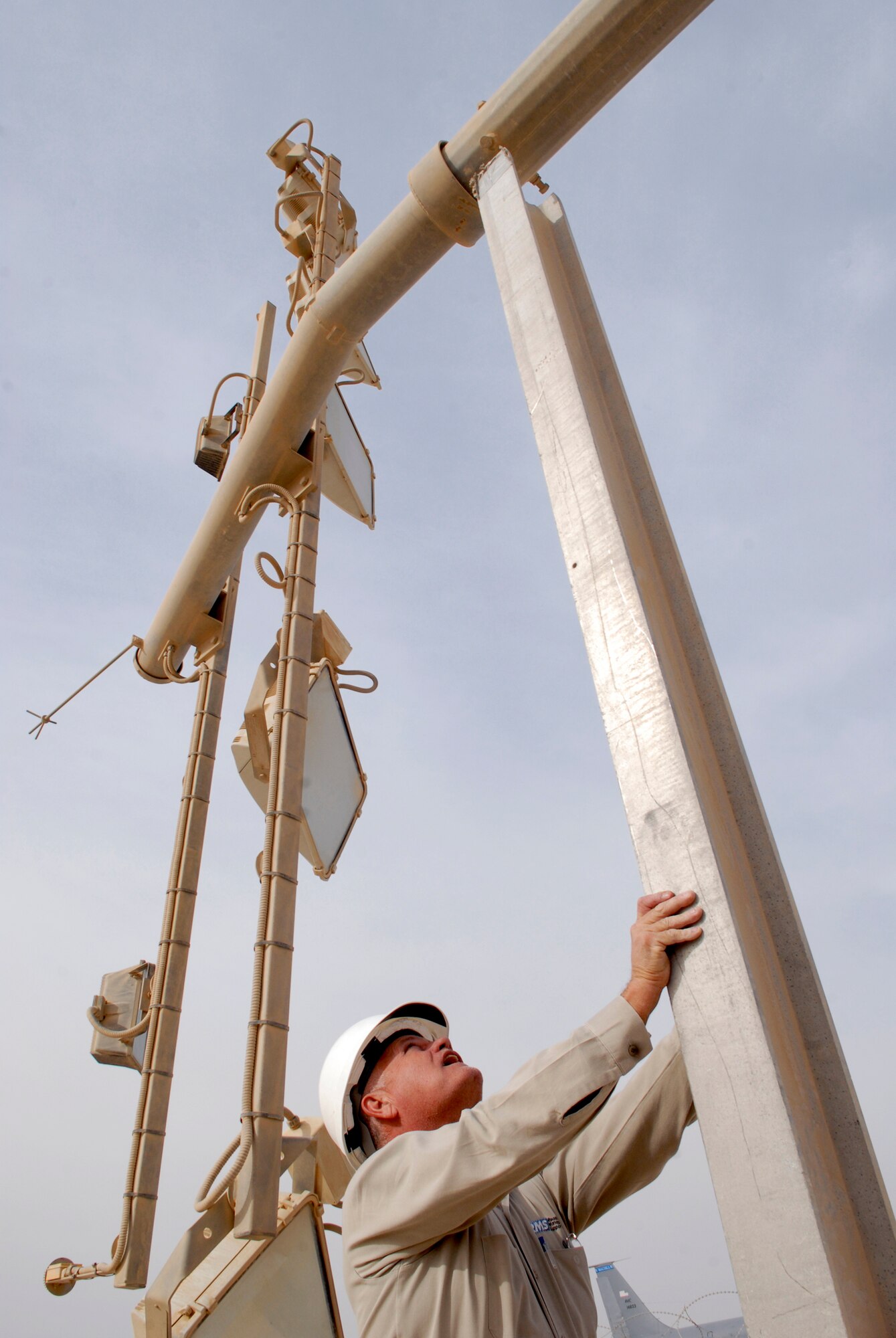John Nettles, a 379th Civil Engineer Squadron Readiness Management Support (RMS) Contractor, sets a support stand for a ramp parking light tower to rest on for repair, Mar. 4, 2009, at an undisclosed location in Southwest Asia.  Mr. Nettles hails from McComb, Miss and is here in support of Operations Iraqi and Enduring Freedom and Combined Joint Task Force - Horn of Africa.  (U.S. Air Force photo by Senior Airman Andrew Satran/released)