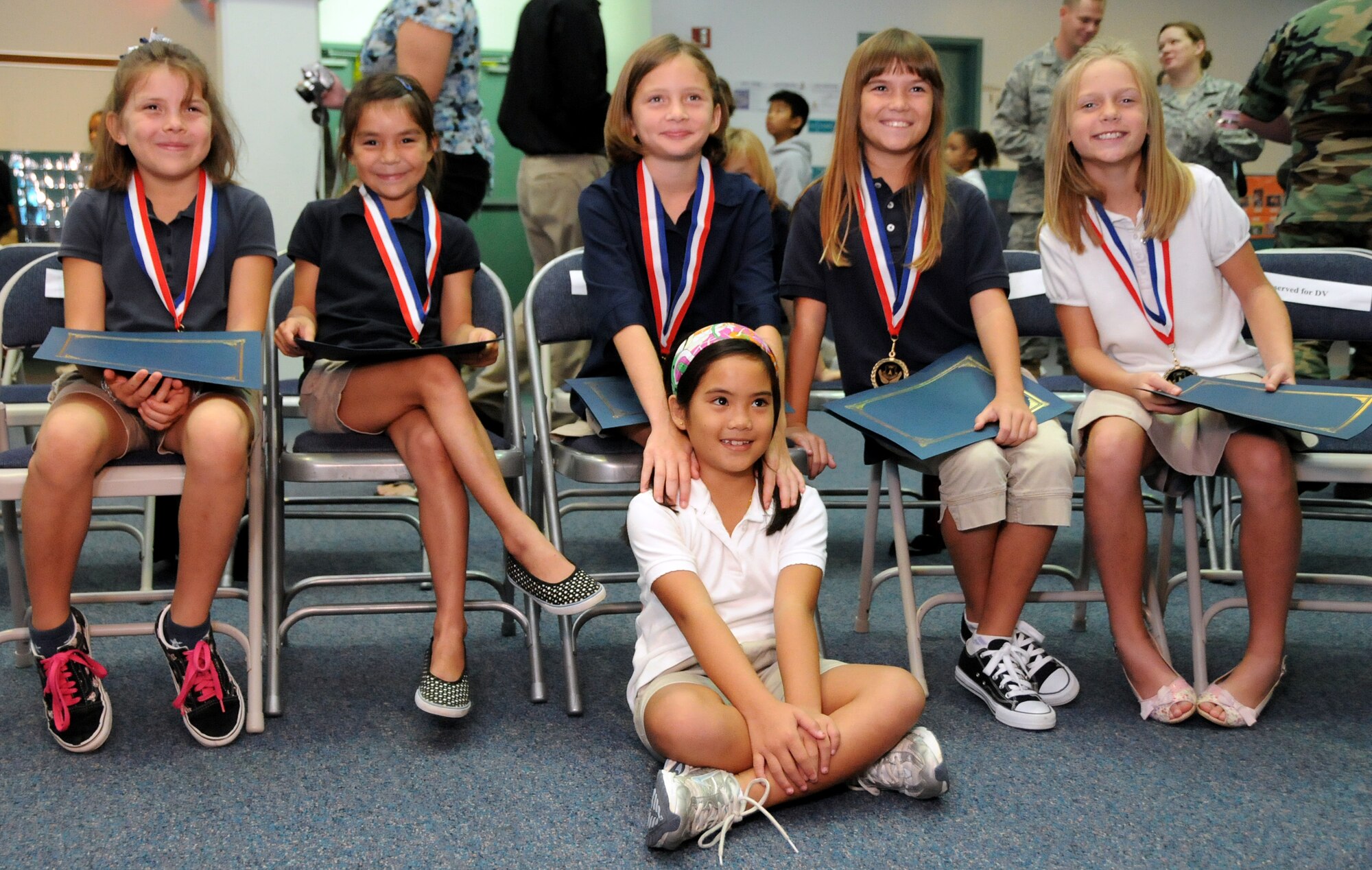 ANDERSEN AIR FORCE BASE, Guam - Jaeleen Jaylo takes a moment for a picture with her heroic friends Katelyn and Mackenzie Powell, Brooke Hummel, Aliyah Andersen,and Nikki MacKeller after the Andersen Elementary School Awards Ceremony here March 4. If not for their quick reaction to garner aid for Jaeleen at the pool that afternoon, she may have drowned. (U.S. Air Force photo by Airman 1st Class Courtney Witt)