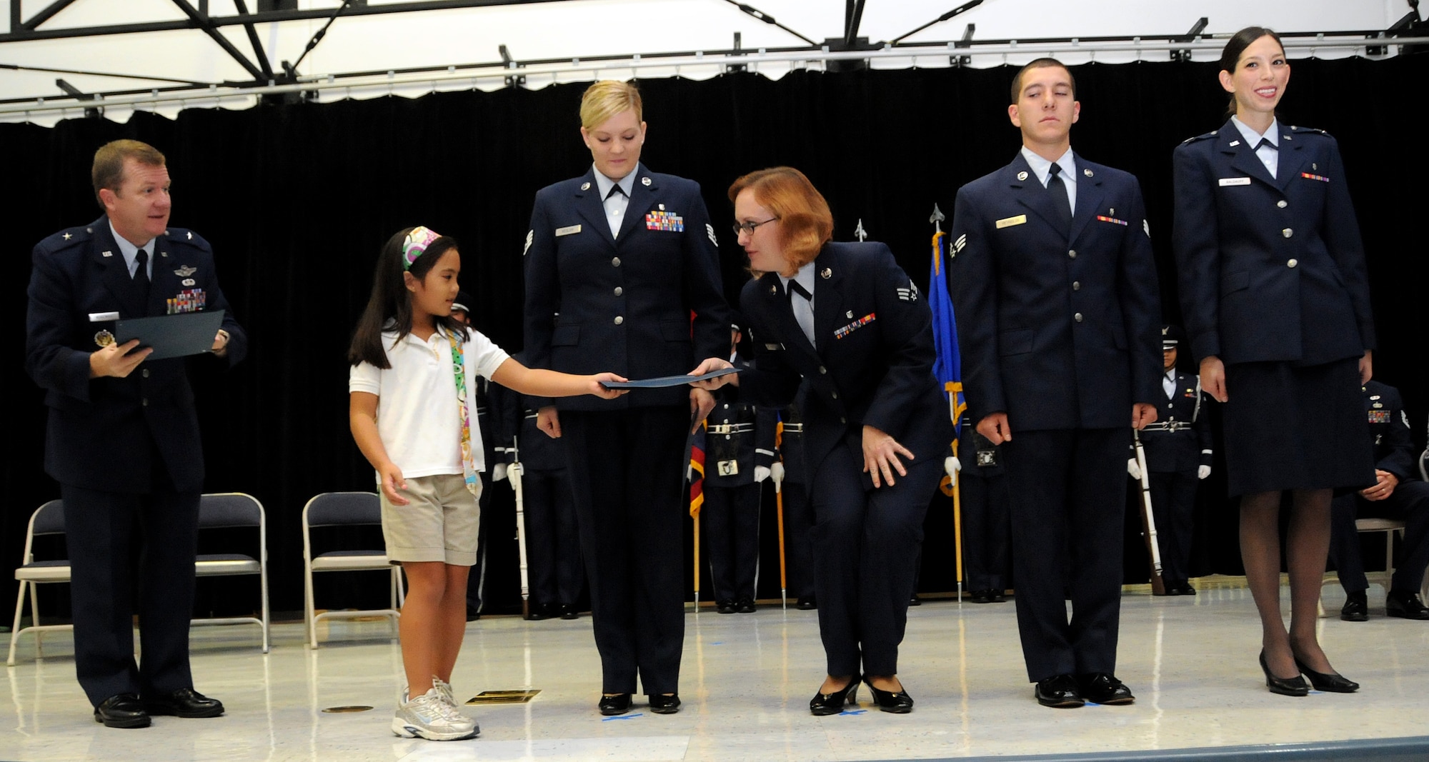 ANDERSEN AIR FORCE BASE, Guam - Jaeleen Jaylo presents first responder Senior Airman Andrea Szerzo with a certificate of appreciation during the Andersen Elementary School Awards Ceremony March 4. The quick responses and actions of these medical professionals were instrumental to Jaeleen Jaylo's positive outcome. (U.S. Air Force photo by Airman 1st Class Courtney Witt)
 
