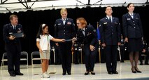 ANDERSEN AIR FORCE BASE, Guam - Jaeleen Jaylo presents first responder Senior Airman Andrea Szerzo with a certificate of appreciation during the Andersen Elementary School Awards Ceremony March 4. The quick responses and actions of these medical professionals were instrumental to Jaeleen Jaylo's positive outcome. (U.S. Air Force photo by Airman 1st Class Courtney Witt)
 