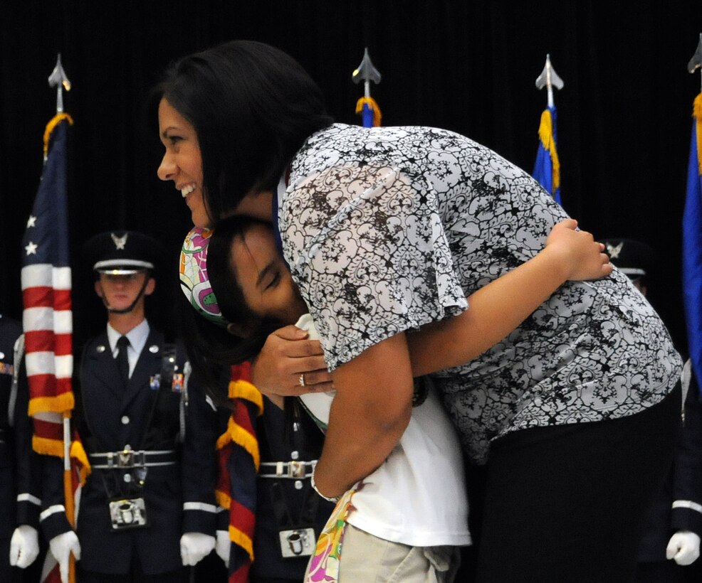 ANDERSEN AIR FORCE BASE, Guam - Jaeleen Jaylo gives a hug to Mrs. Gina Andersen, Department of Defense Education Activity Nurse, for her heroic efforts during the Andersen Elementary School Awards Ceremony here March 4. Mrs. Andersen was presented with for aiding CPR until first responders arrived on the scene.  (U.S. Air Force photo by Airman 1st Class Courtney Witt)

