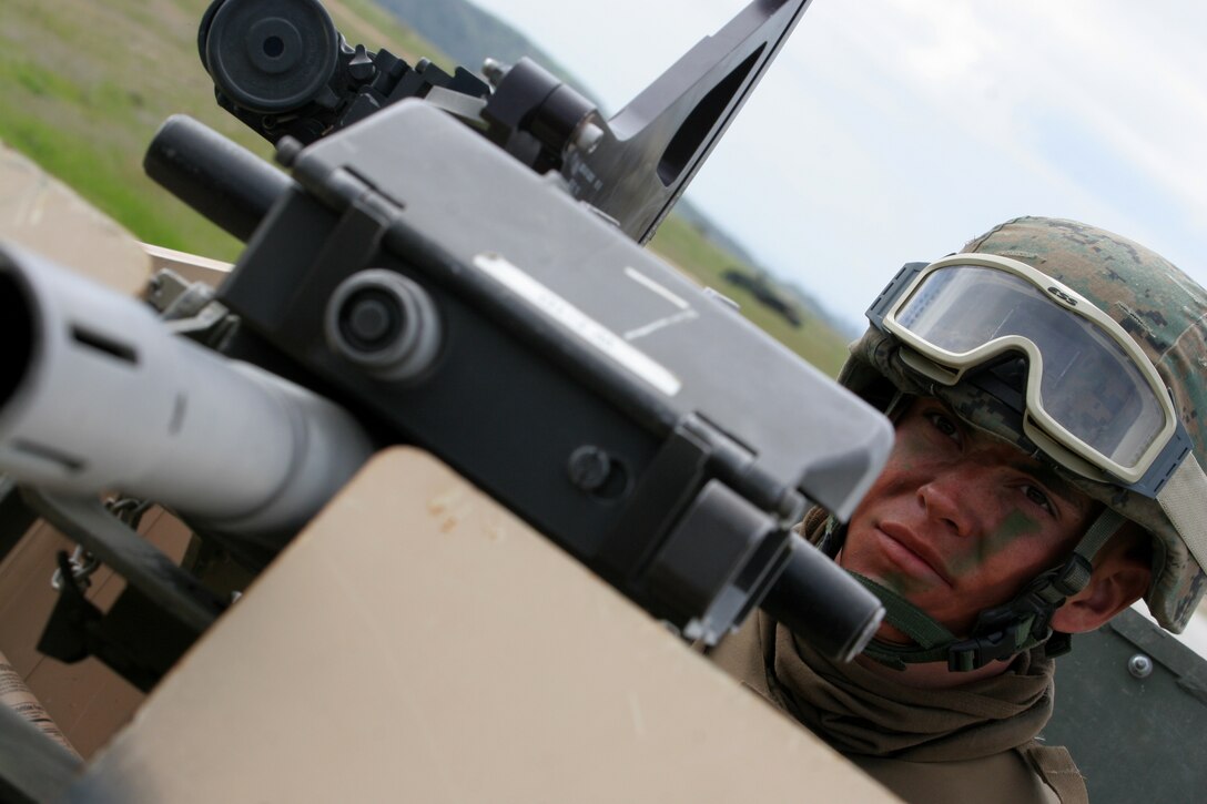 Cpl. Justin Davis peers over the barrel of a MK-19 40mm grenade launcher during a practice raid here March 4. Davis and other infantry Marines from 2nd Battalion, 4th Marine Regiment, conducted training missions March 2-6 as part of 11th Marine Expeditionary Unit exercise, which focuses on Marine Air Ground Task Force planning and execution.