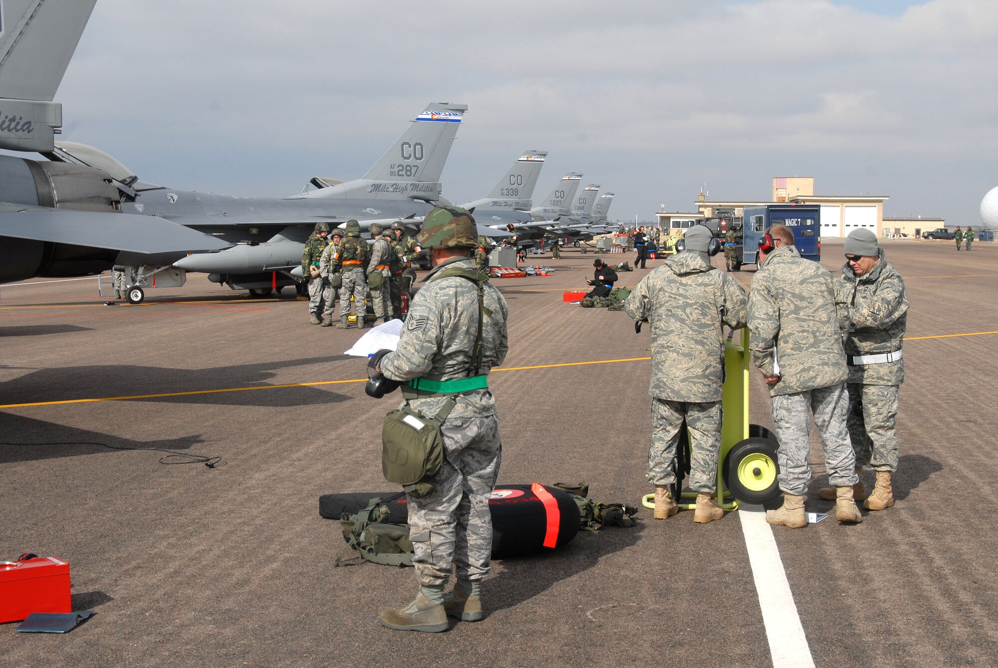 Members of the 140th Wing, Colorado Air National Guard, undergo maintenance procedures to ensure that the F-16C aircraft are ready for war during a Phase 1 Operational Readiness Inspection at Buckley Air Force Base.  Inspectors are everpresent and study notes at the fire supression bottle (right).  (Photo by SMSgt John Rohrer, 140th Wing Public Affairs)