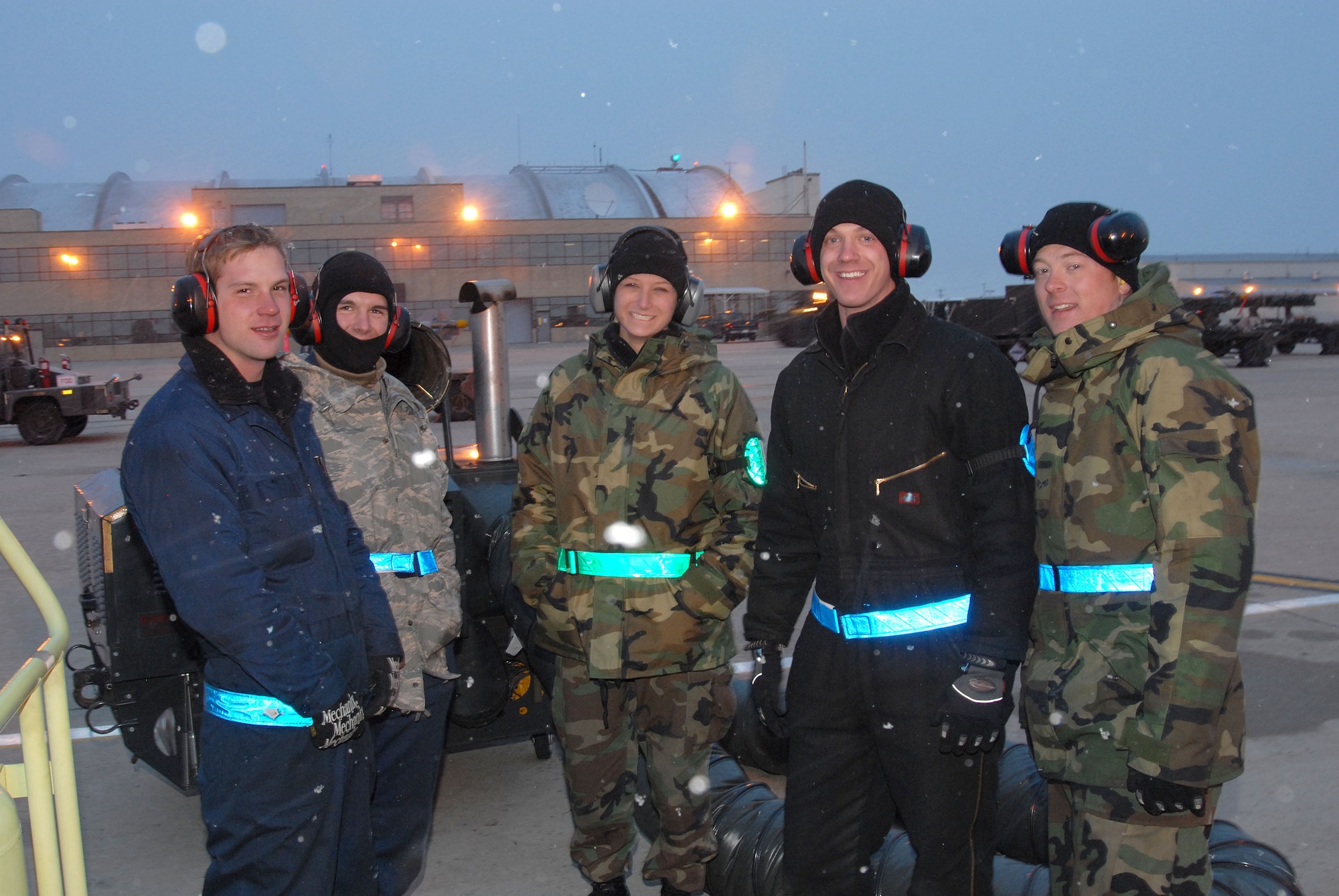 Crew Cheifs (from left to right) SrA Jeffrey Perizzolo, A1C Austin Smith, SrA Anne Kollar, SrA Jared Phillips, and SrA Travis Tanner brave the cold and snowy conditions while working on the flightline during the 140th Wing's Phase 1 Operational Readiness Inspection.  Photo by: SMSgt John Rohrer; 140th Wing Public Affairs.