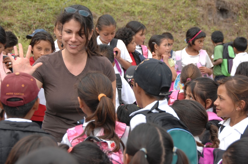 Rosanna Kingston, founder of the Give a Kid a Backpack Foundation, spends time getting to know the children who have received the fruits of her labor.  Mrs. Kingston coordinates volunteers in the U.S. to raise money and supply backpacks and other school supplies to children who cannot afford them.  (U.S. Army photo/Specialist Christopher Wellner)