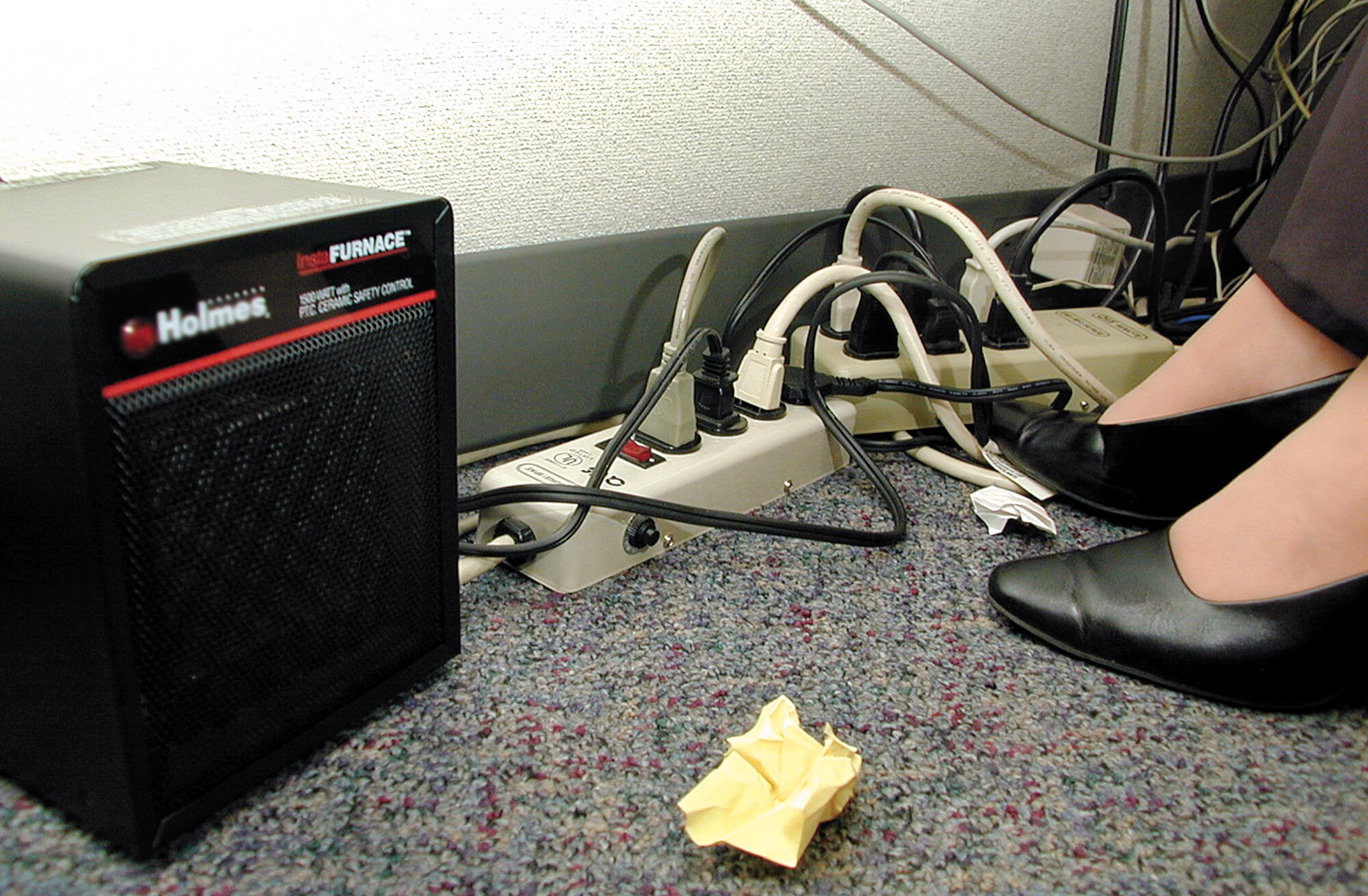 Safety hazards may exist anywhere. While industrial areas are seen to have more potential for serious hazards, there are plenty of opportunities for hazards in an office environment as well. Daisy chaining power strips, using space heaters, an abundance of trash, all pose safety risks. The Voluntary Protection Program asks employees to actively participate in alleviating workplace safety risks. (Air Force photo/Margo Wright)