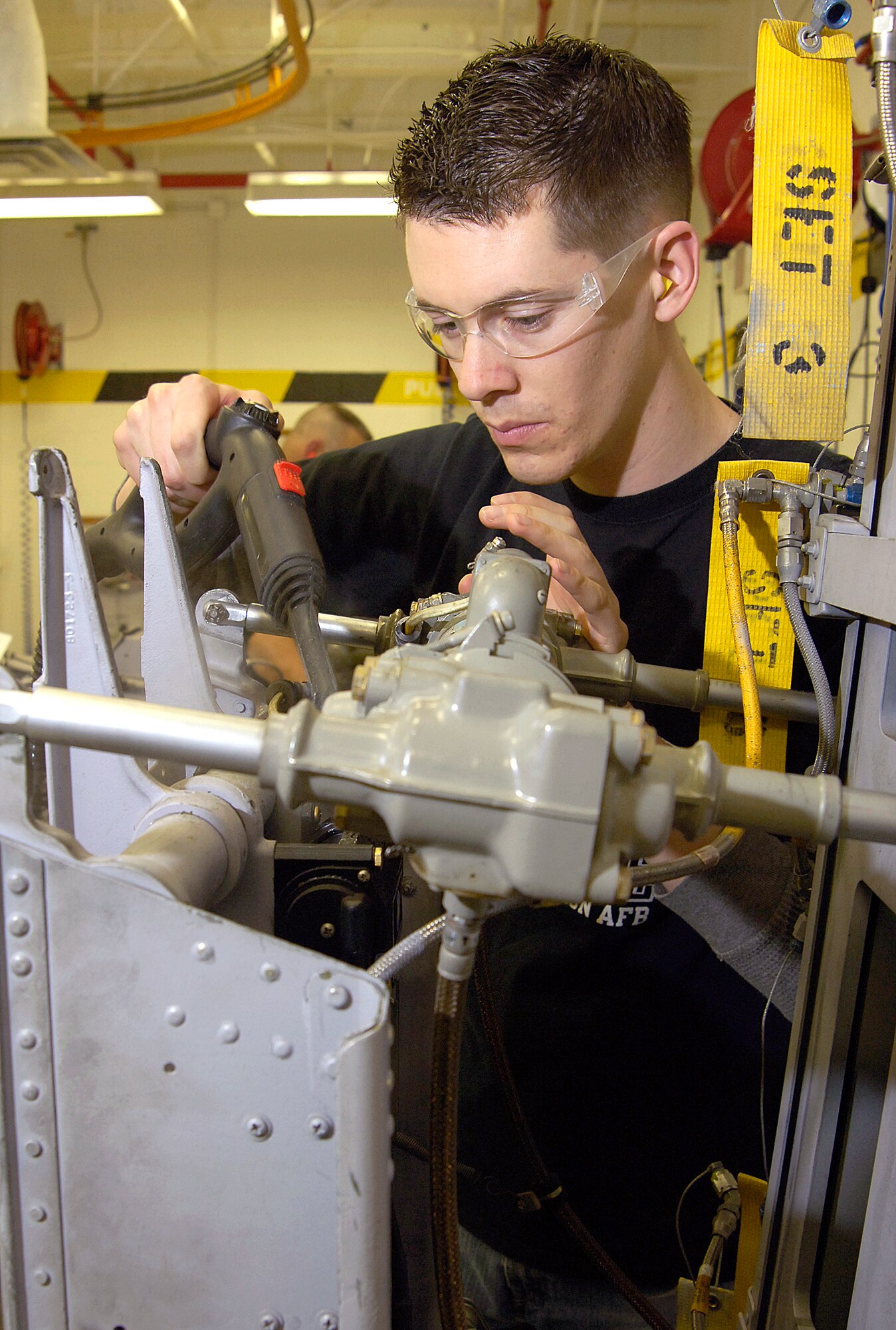 Brian Baker steam cleans a B-52 pilot’s ejection seat in the Egress Shop located in Bldg. 2122. The seat came into service 21 years before the technician was born.(Air Force photo/Margo Wright)