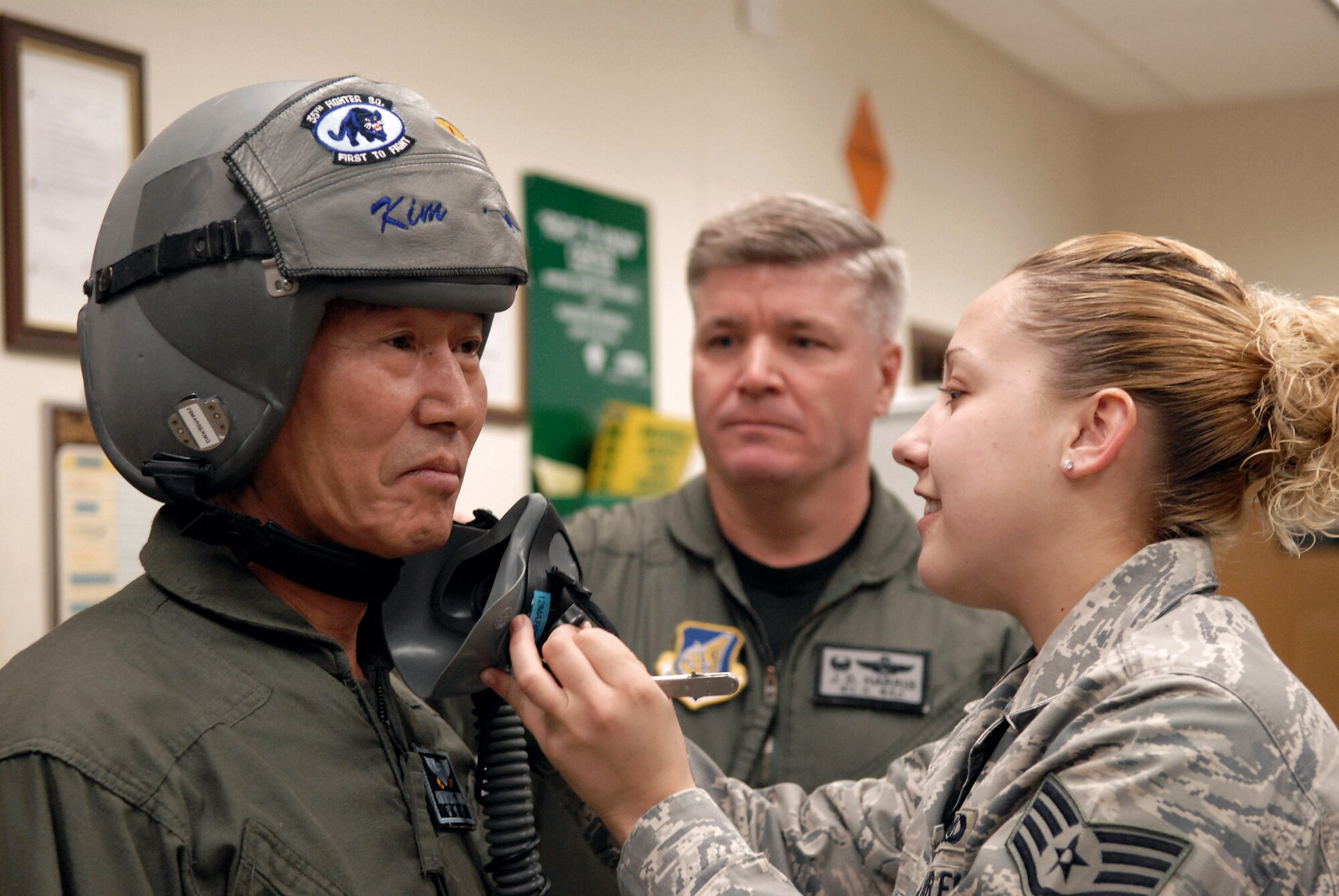 Kim Myung Jung, Gunsan City's Korean National Police chief, is fitted for an oxygen mask by Staff Sgt. Kimberly Gage March 4 prior to an F-16 Fighting Falcon ride at nearby Kunsan Air Base, Republic of Korea. Mr. Kim participated in the Pilot for a Day program, part of United States Force Korea's Good Neighbor Program.  Sergeant Gage is an aircrew flight equipment technician with the 8th Operations Support Squadron.  (U.S. Air Force photo/Senior Airman Angela Ruiz)