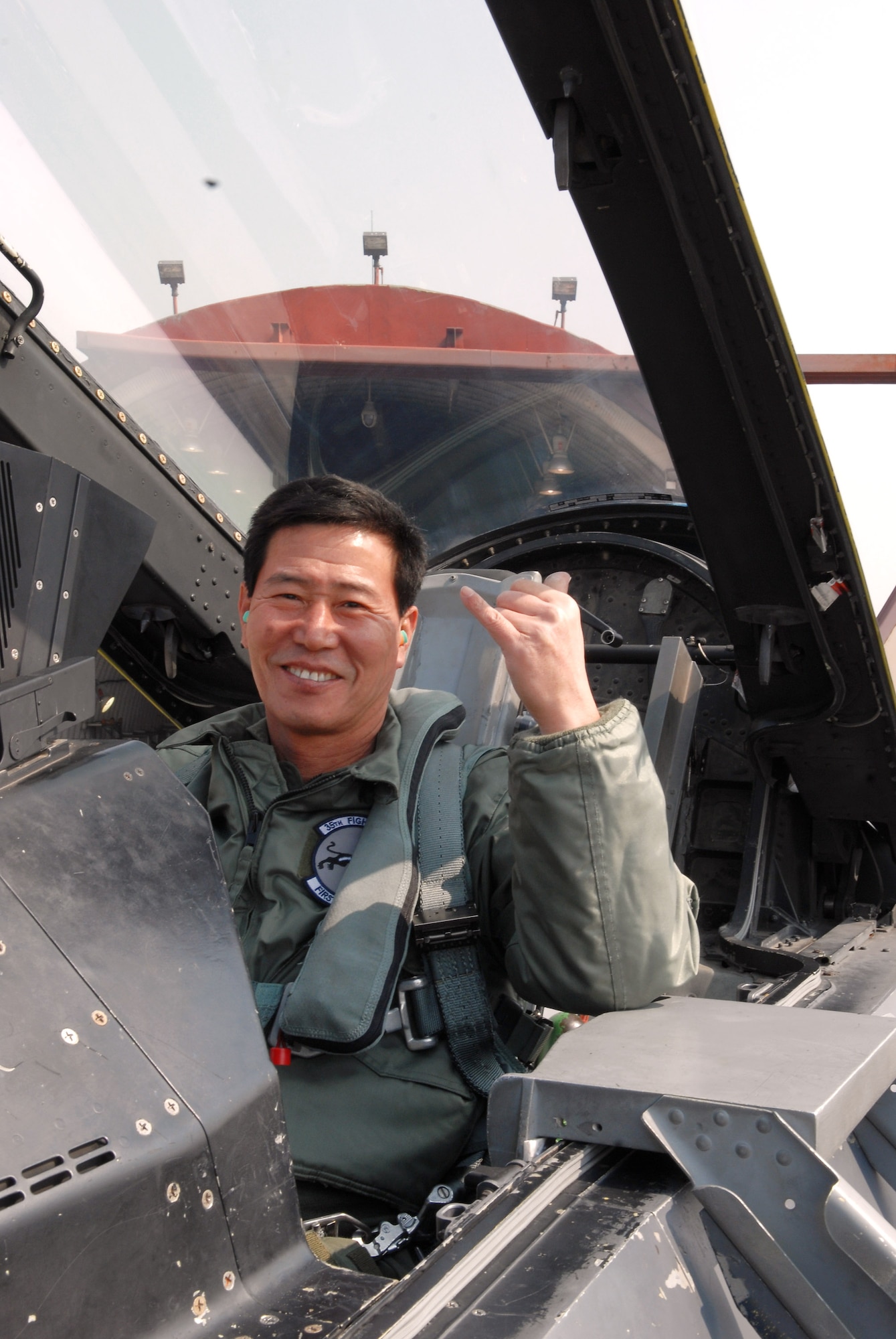 Kim Myung Jung, Gunsan City's Korean National Police chief, expresses his excitement after taking a high-speed taxi ride in an F-16 Fighting Falcon March 4 at Kunsan Air Base, Republic of Korea. Mr. Kim participated in the base's Pilot for a Day program which is part of United States Force Korea's Good Neighbor Program. (U.S. Air Force photo/Senior Airman Angela Ruiz)