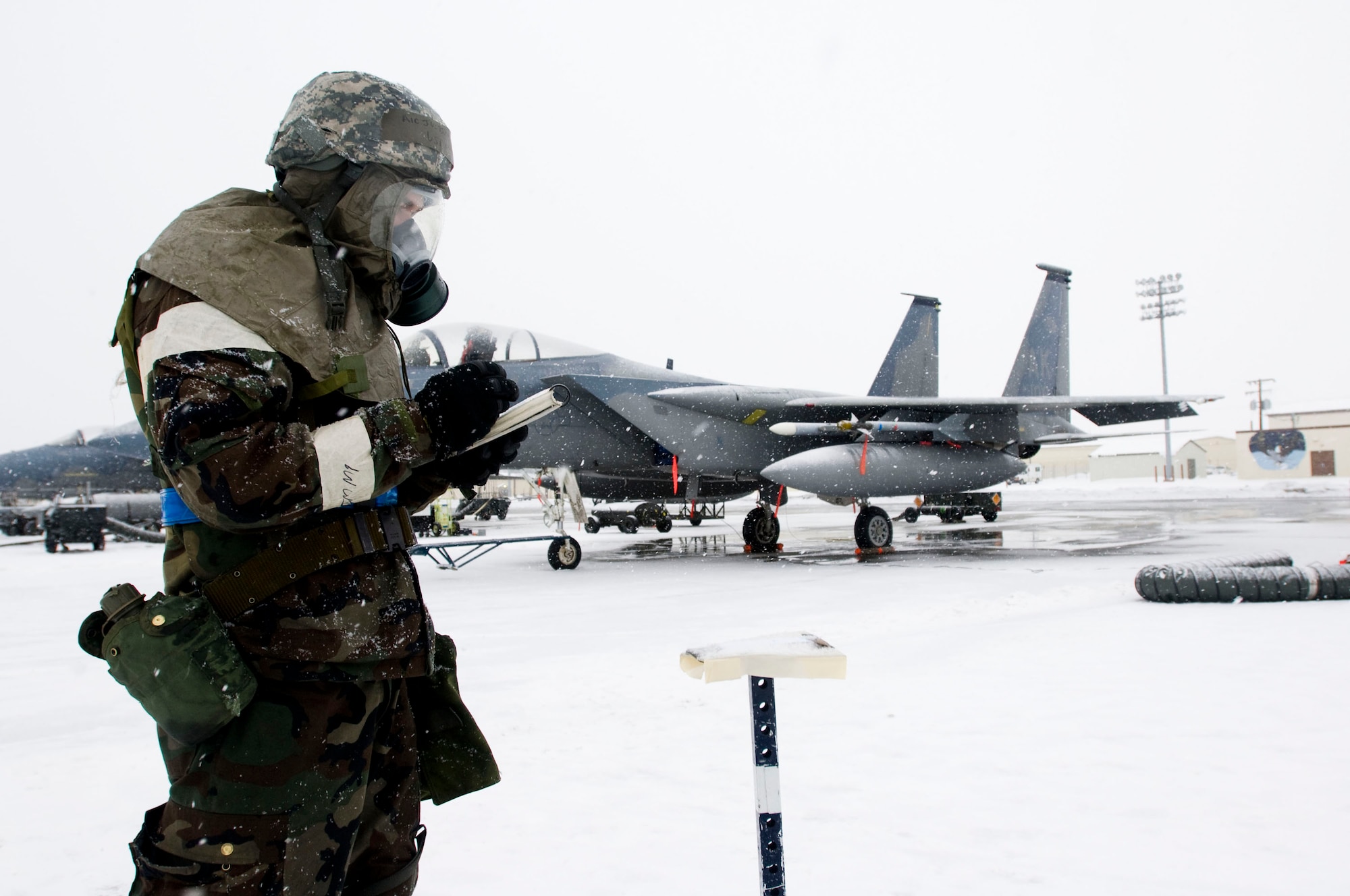 ELMENDORF AIR FORCE BASE, Alaska -- Airman 1st Class Justin Marsh, 19th Aircraft Maintenance Unit, checks M-8 paper after being released from a simulated missile attack on the flight line March 5, 2009. Airmen from 3rd Wing continued working while be evaluated on their ability to survive in combat situations during the operational readiness exercise. (U.S. Air Force photo by Senior Airman Jonathan Steffen)