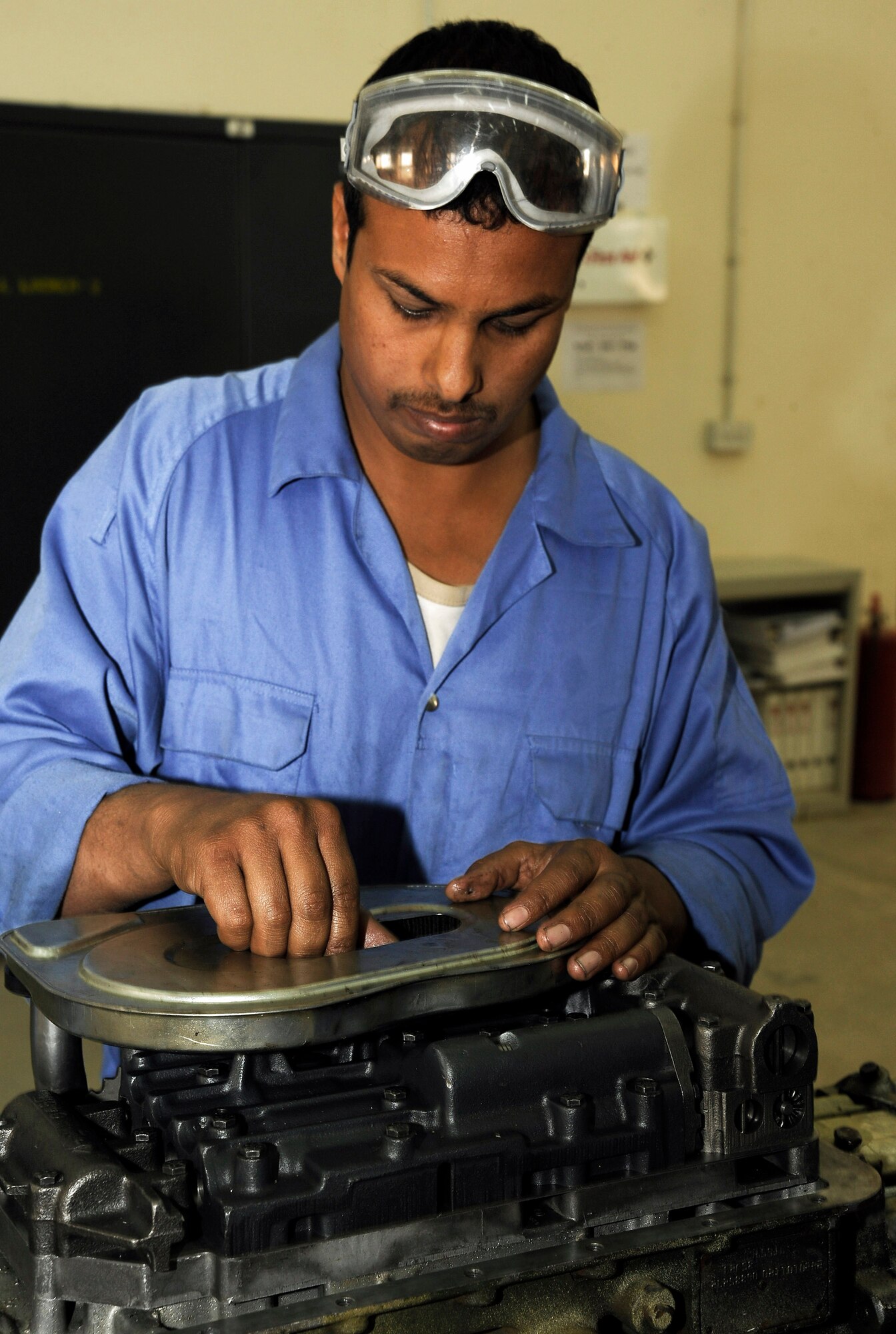 An Iraqi army member works on putting together the transmission for a M1114 HMMWV March 4 at Taji, Iraq. The transmission shop is one of many steps used to totally overhaul a new HMMWV at the Taji national maintenance depot for the Iraqi army. (U.S. Air Force photo/Senior Airman Jacqueline Romero) 

