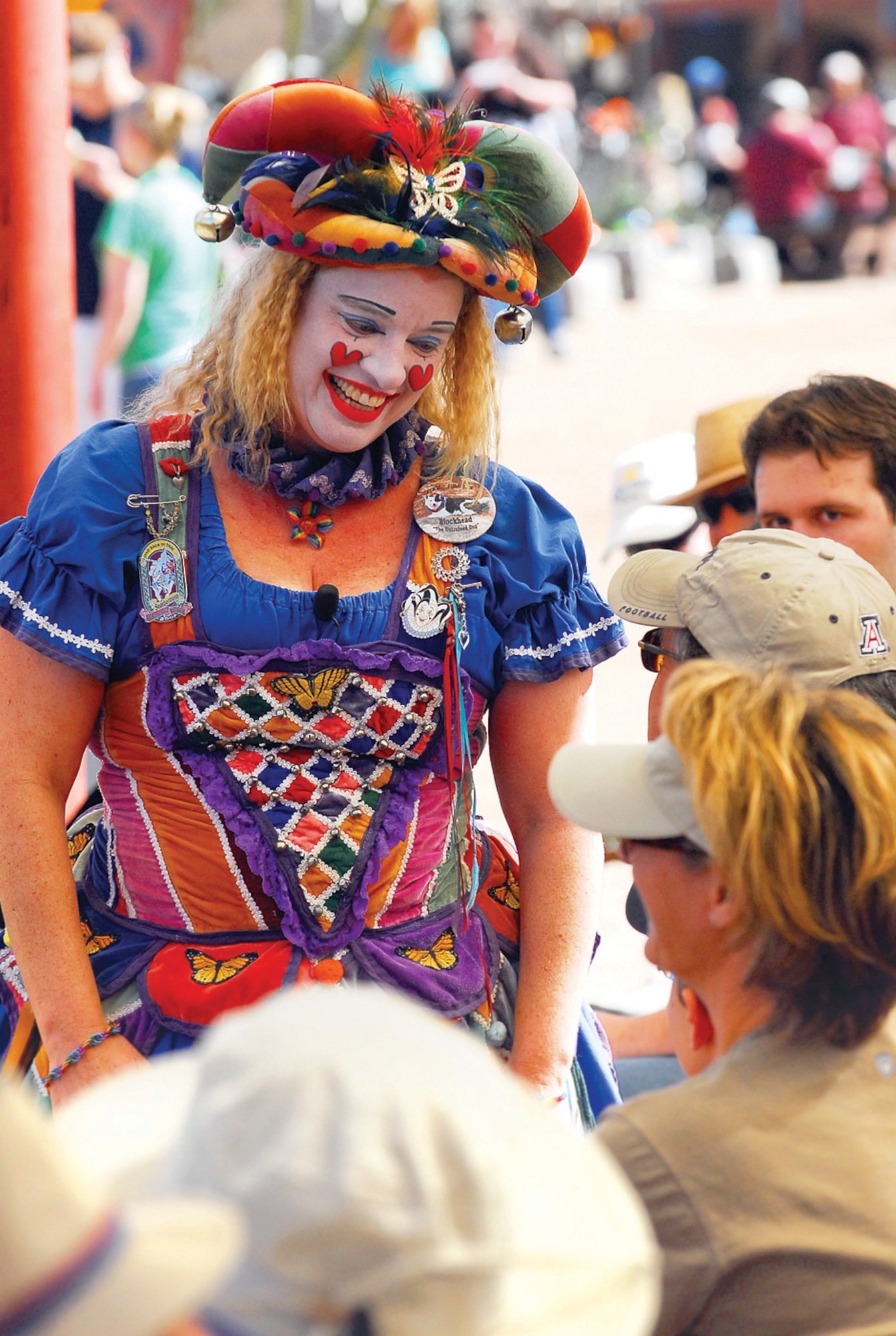 Ima Nut looks through the crowd while performing her show, Fool Hardy, to find a worthy candidate for ‘fool school.’ “I’ve been doing festivals like this for almost 20 years,” Ms. Nut said. “I love to make people laugh — it’s a clown thing.” (U.S. Air Force photo/ C.J. Hatch.)