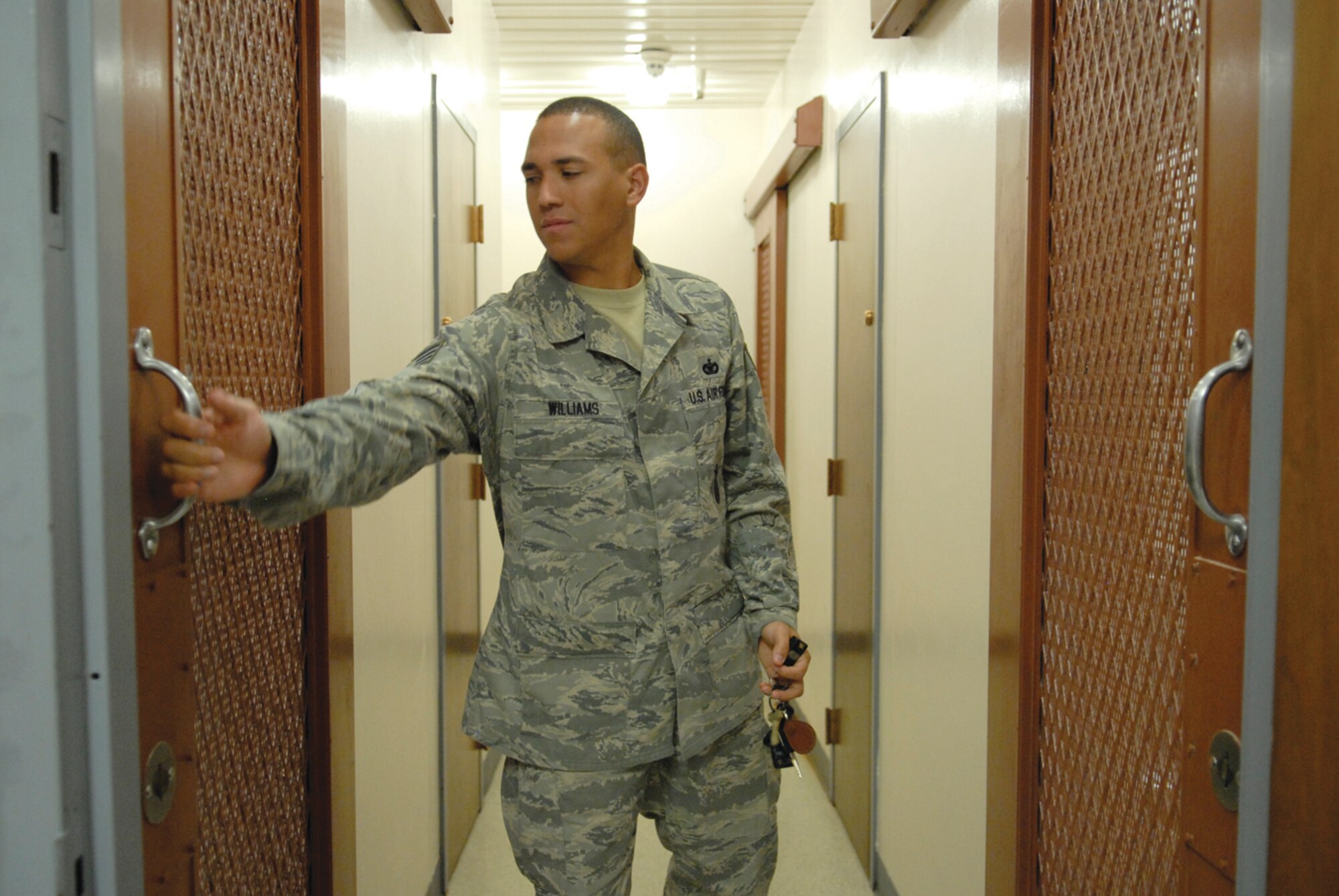 Staff Sgt. Brian Williams, 56th Security Forces Squadron confinement officer, checks a cell door in the confinement area. Airmen are jailed at the facility for reasons including drug and alcohol abuse or domestic violence. (photo/Debbie Silliman-Wolfe)