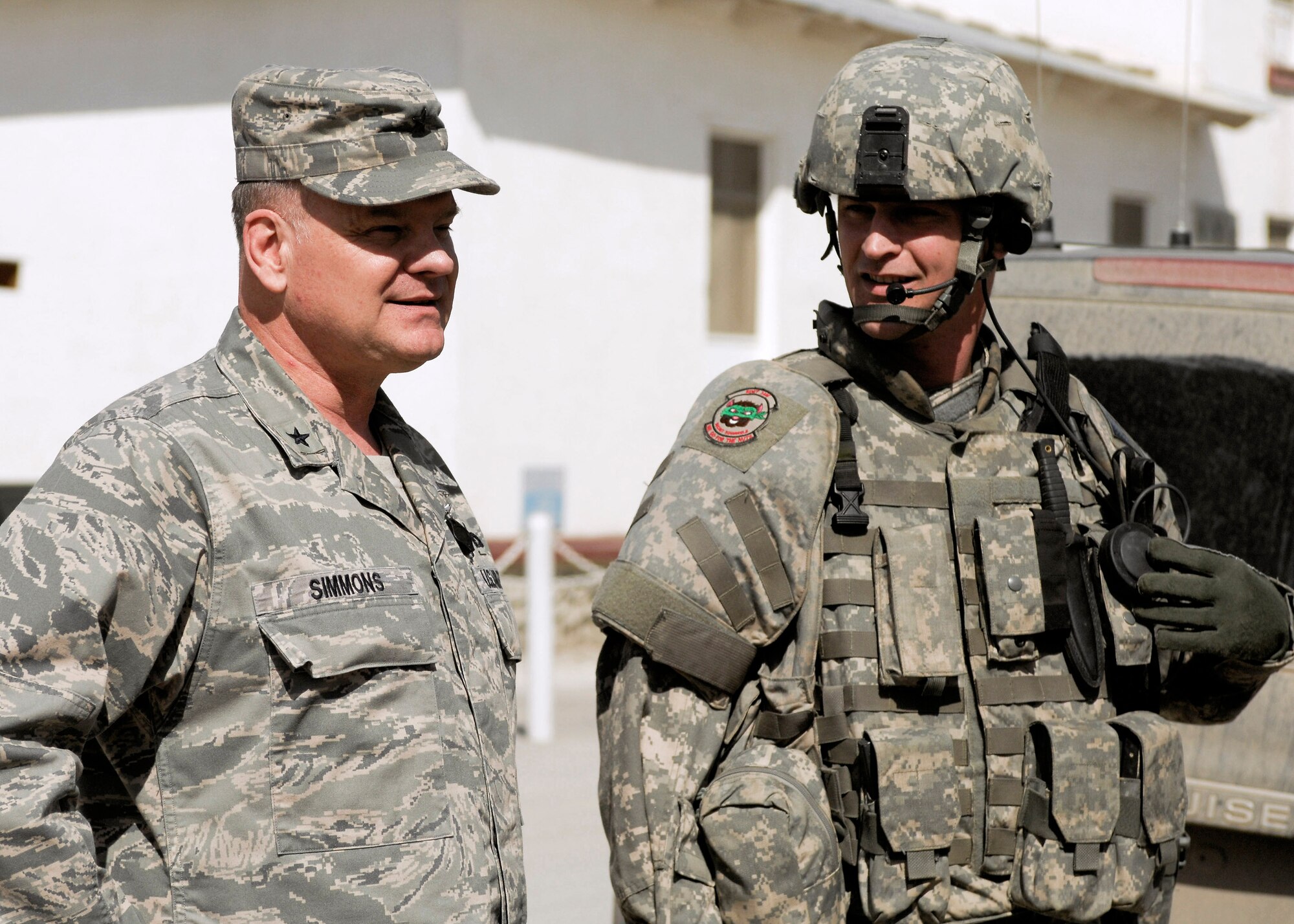 Brig. Gen. Dana Simmons speaks to Tech. Sgt. Brett Brockway before going out on a mission Feb. 25 at Bagram Airfield, Afghanistan. The general spoke with Airmen and Department of Defense civilians contributing to Office of Special Investigations missions in Afghanistan. General Simmons is the Air Force OSI commander. Sergeant Brockway is assigned to the Expeditionary Detachment 2405. (U.S. Air Force photo/Senior Airman Erik Cardenas) 
