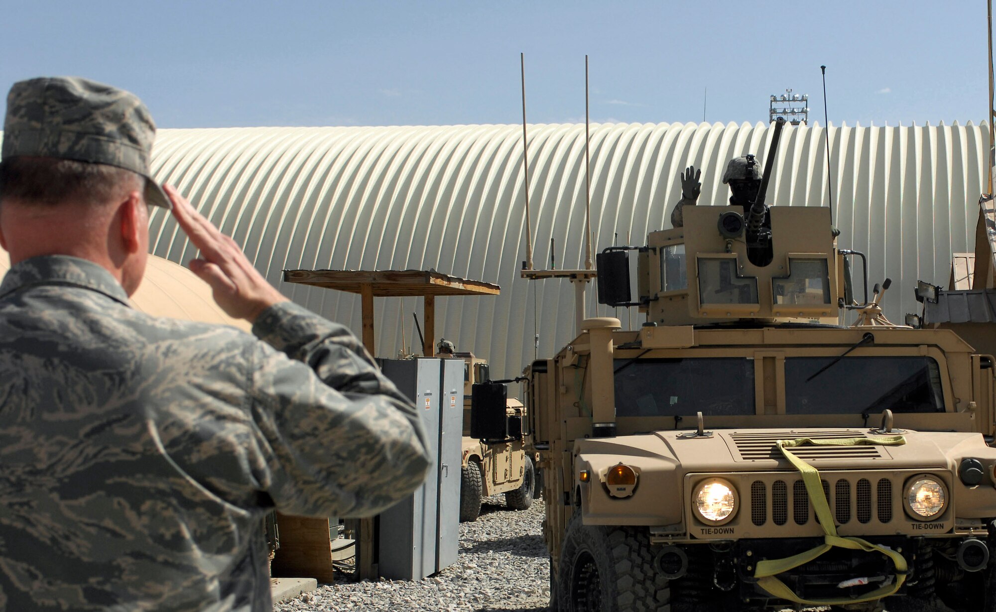 Brig. Gen. Dana Simmons salutes Airmen of the Office of Special Investigations team as they leave on a mission Feb. 25 at Bagram Airfield, Afghanistan. The general spoke with Airmen and Department of Defense civilians contributing to OSI missions in Afghanistan. General Simmons is the Air Force OSI commander. (U.S. Air Force photo/Senior Airman Erik Cardenas) 
