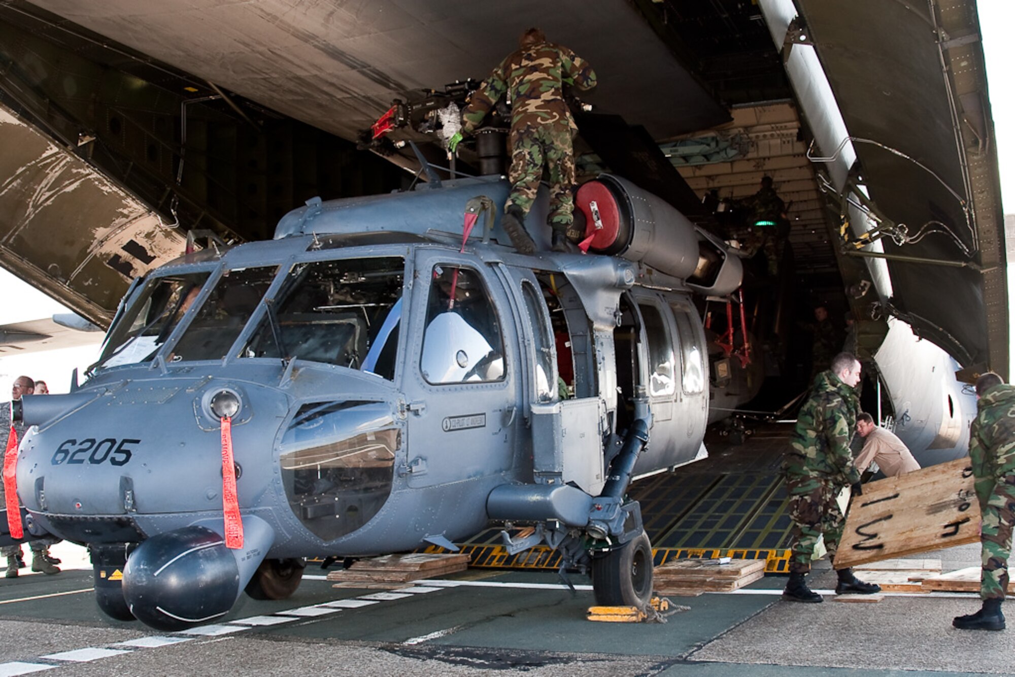 Members of the 56th Rescue Squadron Aircraft Maintenance Unit and Tennessee Air National Guard personnel load an HH-60 Pavehawk into a C-5 Galaxy March 5, 2009 at RAF Lakenheath, England. The 56th RQS is heading to the U.S. for high altitude operations and restricted visibility approach training. (U.S. Air Force photo by Tech. Sgt. Jason Passmore)