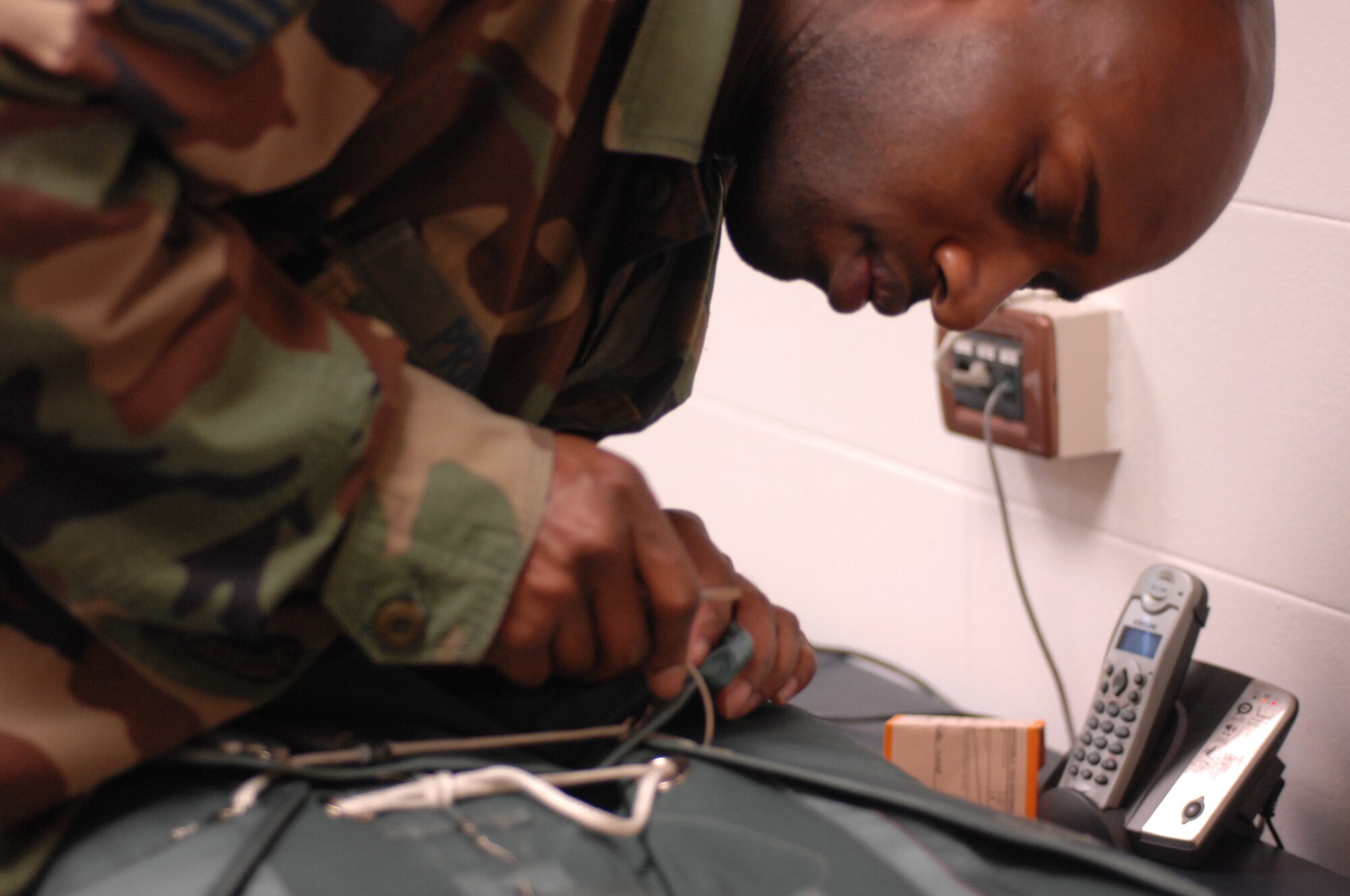 Staff Sgt. Kenyatta Prince closes a survival kit after ensuring all the proper equipment has been placed inside March 3 at the life support office.  Life support Airmen ensure aircrews fly with equipment that enables them to survive the flight and return with honor.  Staff Sgt. Kenyatta Prince is assigned to the 31st Operations Support Squadron.  The wing mission here is to conduct and support air operations in Europe's southern region and to maintain munitions for the North Atlantic Treaty Organization.  (U.S. Air Force photo/Airman 1st Class Tabitha M. Mans)