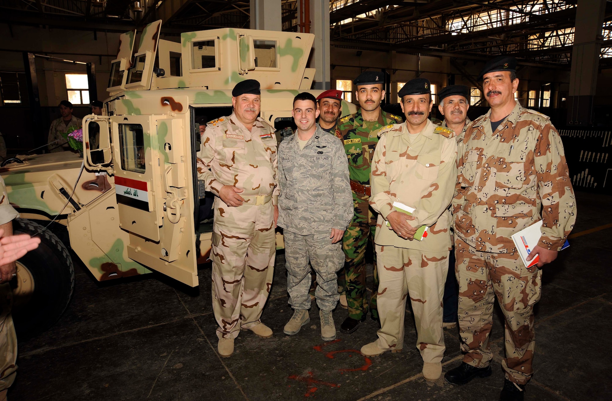 Capt. Jeffrey Allen, 732nd Air Expeditionary Group, stands in front of the first M1114 HMMWV after the unveiling of Project One with Iraqi army at Taji, Iraq March 4, 2009.  Captain Allen is the contract officer representative at the Taji National Maintenance Depot making sure that the Iraqis receive the necessary equipment to make repairs. Captain Allen is a native of Lusby, Md. and is a reservist deployed from Andrews Air Force Base, Md.. (U.S. Air Force photo by Senior Airman Jacqueline Romero/RELEASED)