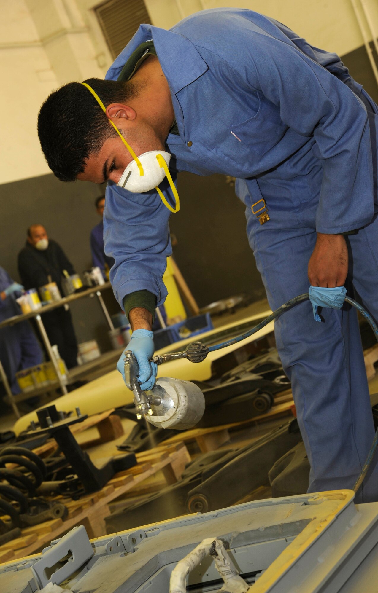 An Iraqi army member puts a coat of paint on the door of a M1114 HMMWV at Taji, Iraq March 4, 2009.  The paint shop is the last step in the HMMWV restoration process at the Taji National Maintenance Depot for the Iraqi army.  (U.S. Air Force Photo by Senior Airman Jacqueline Romero/RELEASED)