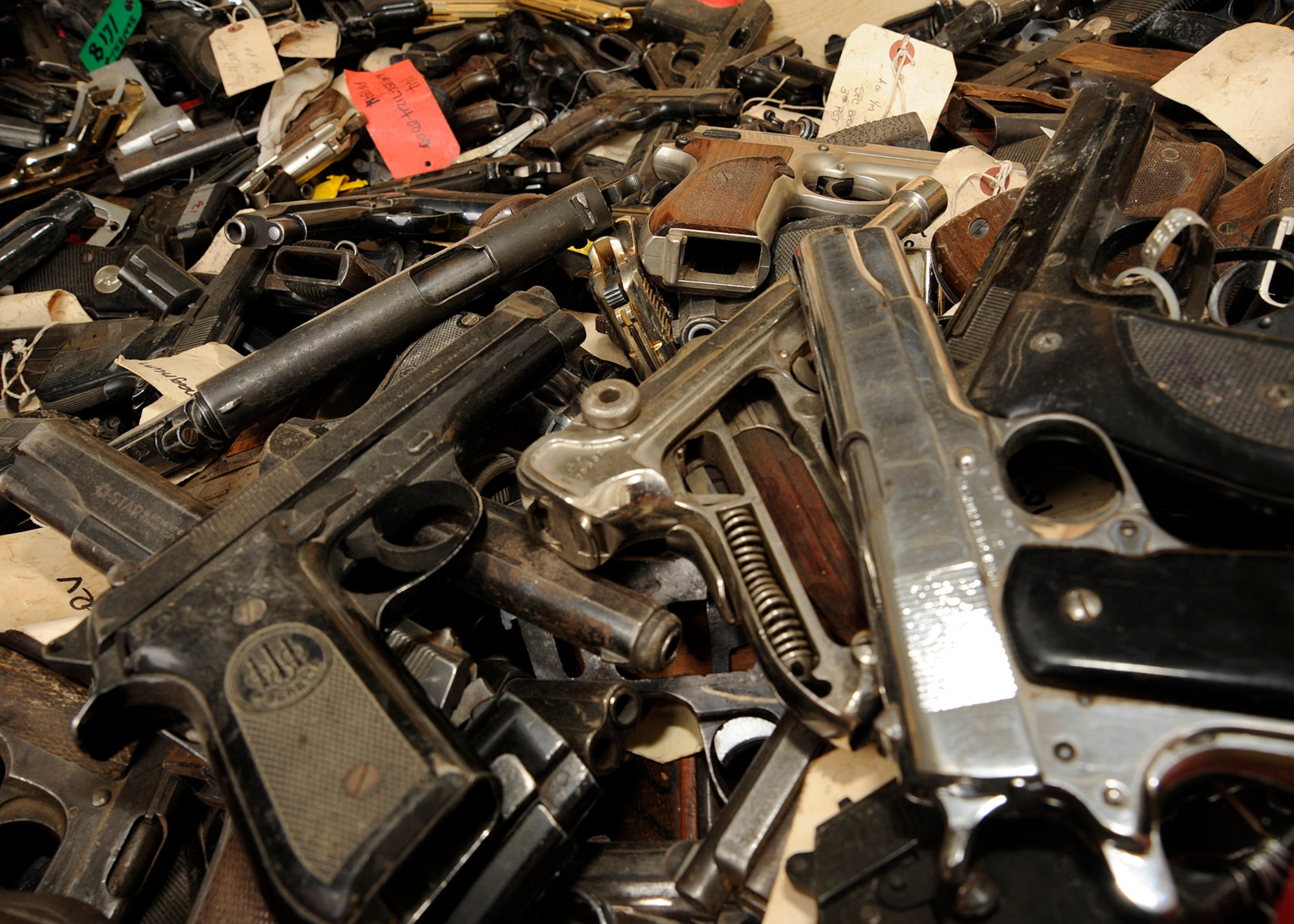 Many of the pistols sit in this container waiting to be inventoried after they have been found around Iraq March 4, 2009. The Taji National Maintenance Depot is responsible for taking in all captured small arms, artillery, and any other weapon devices. Some of the weapons will be destroyed and others will be able given back to the Iraqi army for use. (U.S. Air Force photo by Senior Airman Jacqueline Romero/RELEASED)