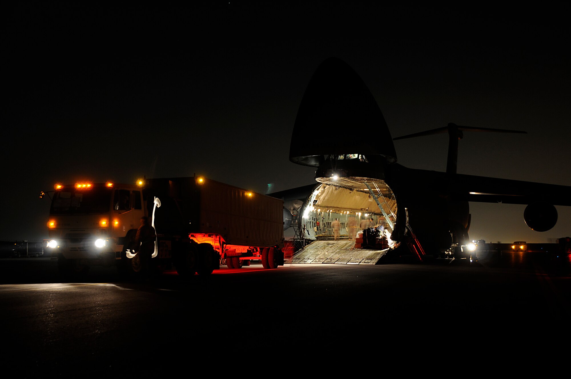 SOUTHWEST ASIA - Vehicles and equipment belonging to the 5-52 Air Defense Artillery Battalion are unloaded from a C-5 Galaxy, Mar 6. The Army comes to the 380th Air Expeditionary Wing bringing with them the first Patriot Battery to the wing, improving air defense capability. The Army will be incorporated into the 380th AEW's mission in support of Operations Iraqi and Enduring Freedom and Joint Task Force Horn of Africa. The 5-52 Air Defense Artillery Battalion is deployed out of Fort Bliss, TX. (U.S. Air Force photo by Senior Airman Brian J. Ellis) (Released)