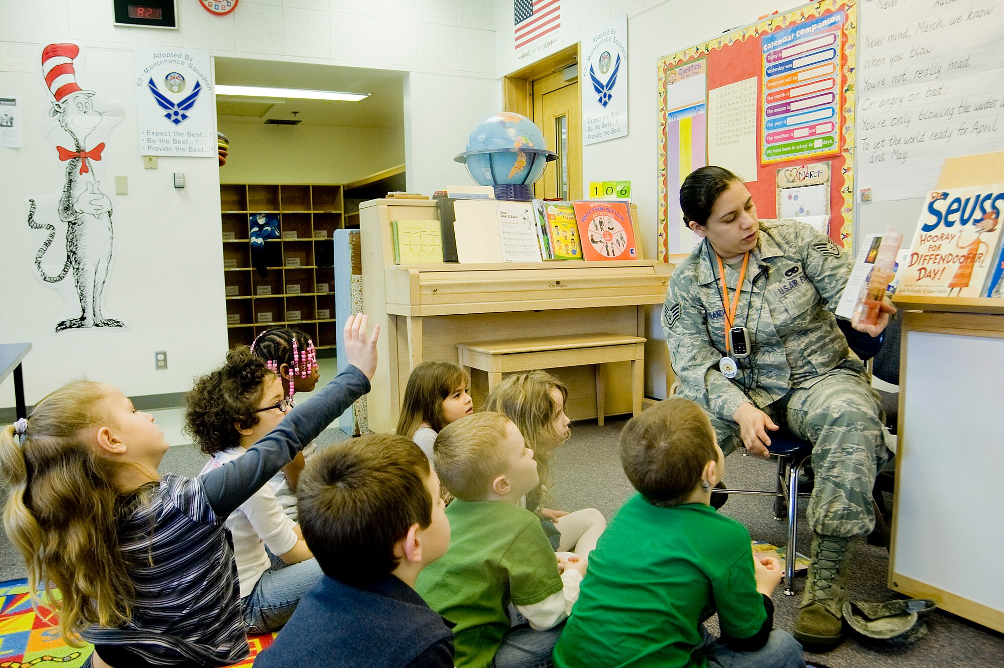 Staff Sgt. Arlene Fernandez, 62nd Maintenance Squadron, reads to Carter Lake Elementary kindergarten students March 2. (U.S. Air Force photo/Abner Guzman)