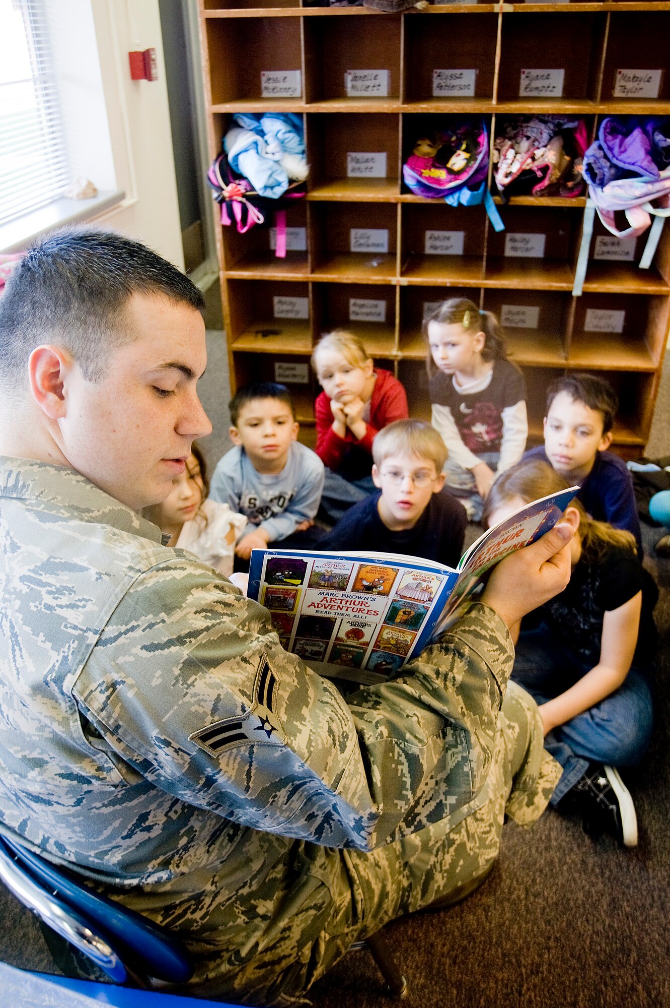 Airman 1st Class Jacob Stevens, 62nd Maintenance Squadron "buddy reader", shares a story with the kindergarten class March 2. (U.S. Air Force photo/Abner Guzman)