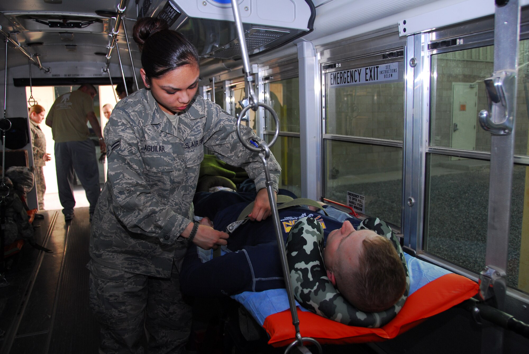 SOUTHWEST ASIA -- Airman 1st Class Alyssa Aguilar, 386th Expeditionary Medical Group, removes straps from a patients litter after arriving at the Contingency Aero Medical Staging Facility at an air base in Southwest Asia, Mar. 1. The CASF at the base is one of two medical staging facilities in the Area of Responsibility, assisting all branches of the military and coalition forces. Airman Aguilar is deployed from Wright-Patterson AFB, Ohio, and is originally from Sacramento, Calif. (U.S. Air Force photo/ Senior Airman Courtney Richardson)