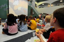 ANDERSEN AIR FORCE BASE, Guam - Andersen Elementary School student's watch Dr. Seuss videos while eating green eggs and ham during the Dr. Seuss Book Camp here March 6. The students read several Dr. Seuss books throughout the week with mixtures of worksheets, puzzles and coloring sheets to familiarize themselves with the creative writer. (U.S. Air Force photo by Airman 1st Class Courtney Witt)
