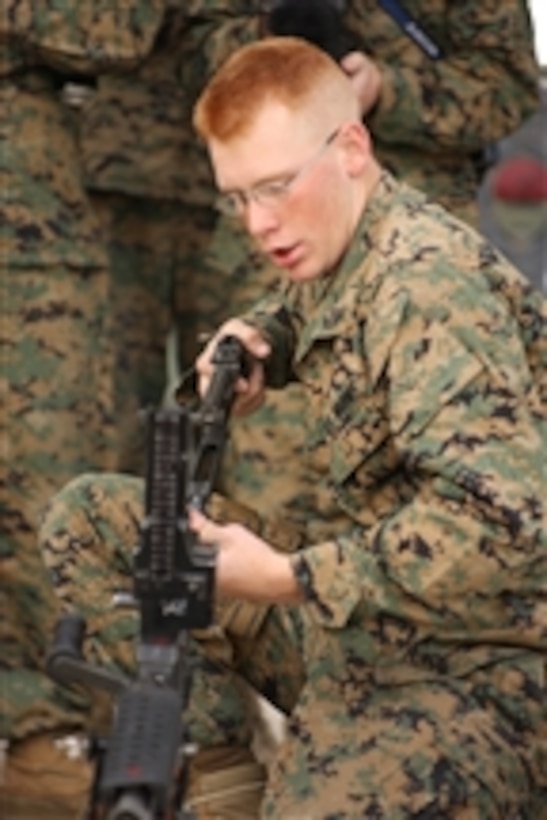 U.S. Marine Corps Cpl. Bryan Warloe from 3d Battalion, 11th Marines Headquarters Battery teaches fellow Marines the proper way to disassemble and reassemble an M-249 squad automatic weapon during a crew serve weapons class at Marine Corps Air Ground Combat Center, Twentynine Palms, Calif., on March 3, 2009.  