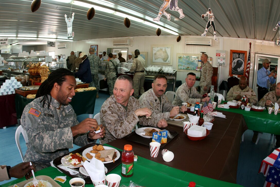 Larry Fitzgerald (left), a wide receiver for the Arizona Cardinals, enjoys lunch with Maj. Todd Peppe, a career reserve Marine and commanding officer of Headquarters and Service Company, 2nd Battalion, 25th Marine Regiment, at the base dining facility March 6, 2009.  Peppe was a communications officer while on active duty.  The Marine Corps Reserve offers an array of leadership opportunities to officers of all rank and MOS.