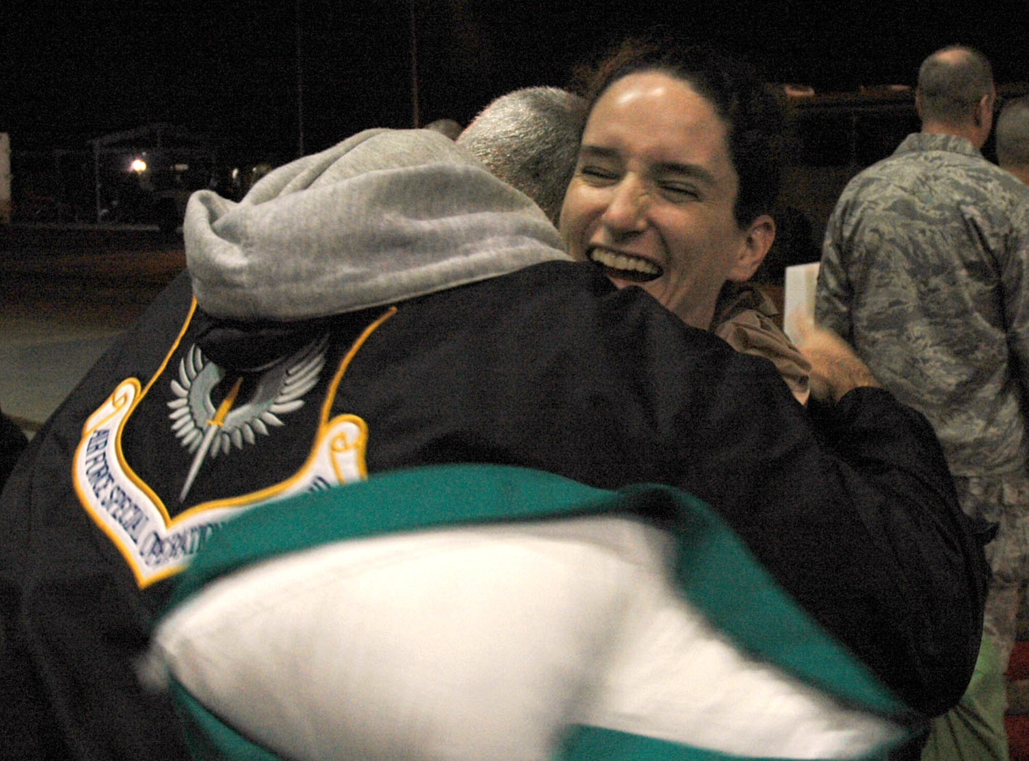 Captain Miriam Williams, 711th Special Operations Squadron, receives a hug from her father, Dr. Reddoch Williams, after arriving back from a 30-day deployment to Afghanistan.  More than 30 members of the 919th Special Operations Wing were greeted by hundreds of family and wellwishers  when they arrived at Hurlburt Field March 7.  U.S. Air Force photo/ Senior Airman Jon McCallum.