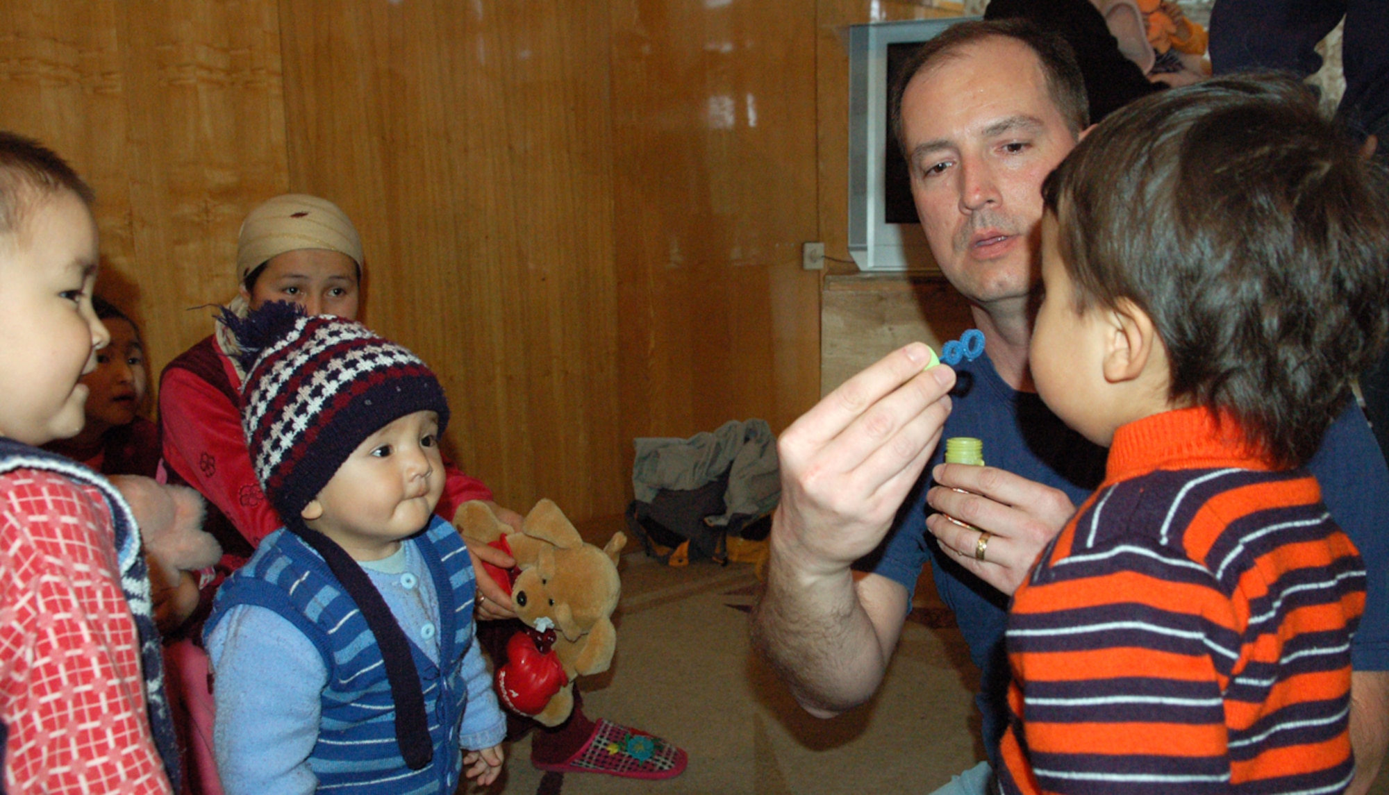 Master Sgt. Ken Hart teaches children the art of bubble blowing during a March 4 visit to the Bishkek Institute of Cardiology, known as the Children's Heart Hospital, in Kyrgyzstan. Airmen with the Manas Air Base Outreach Society spent some of their off-duty time with the young patients in the heart ward. During this visit, MABOS donated approximately $4,500 to the hospital to pay for eight heart surgeries in addition to the 129 others funded since 2003. Sergeant Hart is assigned to the 376th Expeditionary Force Support Squadron and is deployed from the 27th Special Operations Force Support Squadron at Cannon Air Force Base, N.M. He is originally from Augusta, Ga. (U.S. Air Force photo/Maj. Damien Pickart)