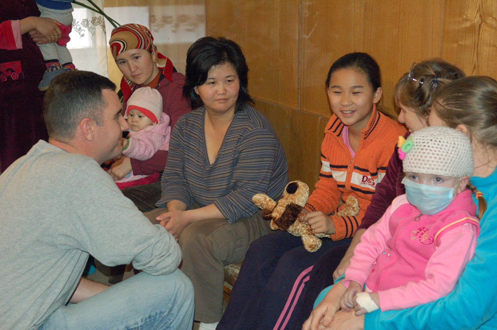 Staff Sgt. Louis Calvao (left) hands out gifts to patients as their families look on during a March 4 visit to the Bishkek Institute of Cardiology, known as the Children's Heart Hospital, in Kyrgyzstan. During their off-duty time, Airmen participate in the Manas Air Base Outreach Society, a private, non-profit organization that supports charities, hospitals and orphanages in the greater Bishkek area and communities near the base. During this visit, MABOS donated approximately $4,500 to the hospital to pay for eight heart surgeries in addition to 129 others funded since 2003. (U.S. Air Force photo/ Maj. Damien Pickart)
