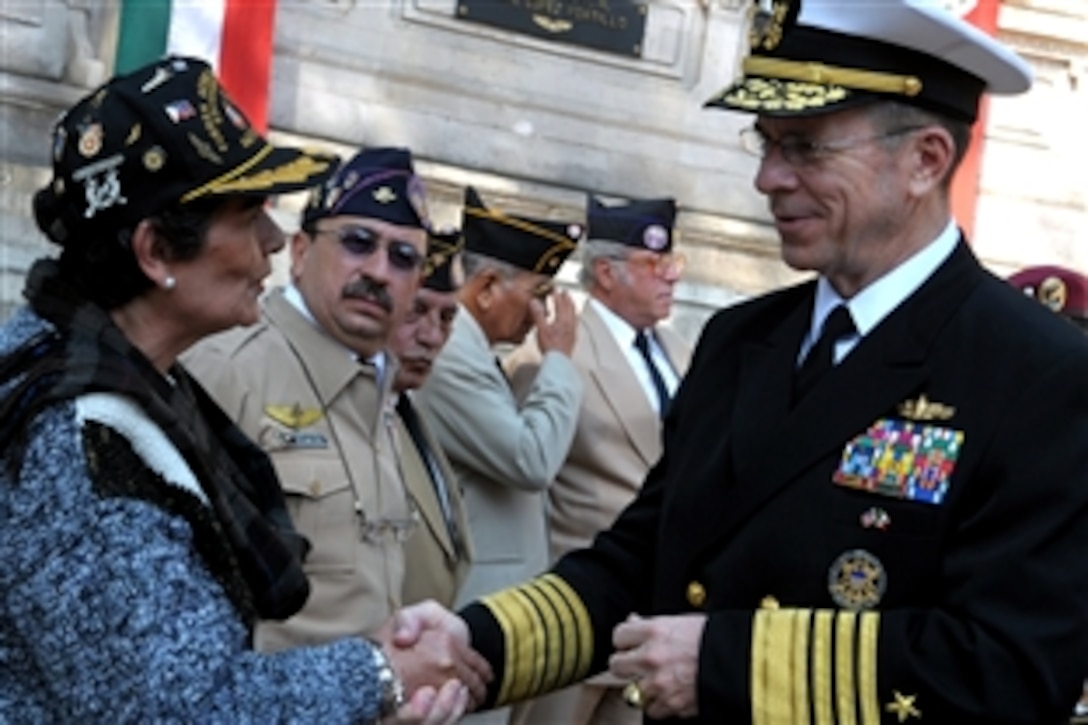 Chairman of the Joint Chiefs of Staff U.S. Navy Adm. Mike Mullen talks to a the spouse of a former 201st Fighter Squadron member at Chapultepec Park in Mexico City, Mexico, March 6, 2009. The chairman laid a wreath at the 201st memorial and talked with former squadron members, who deployed with U.S. forces to the Philippines during World War II. 