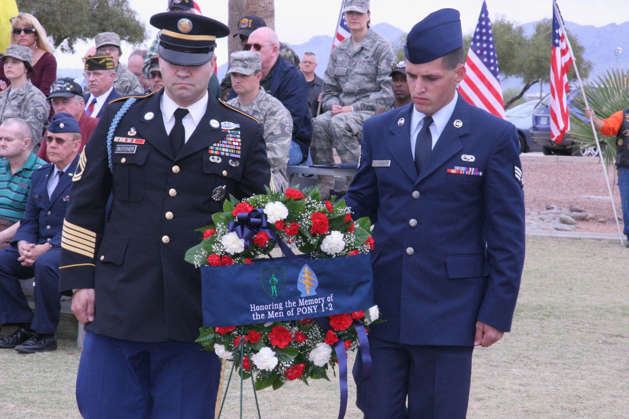 DAVIS-MONTHAN AIR FORCE BASE, Ariz. -- Army Sergeant 1st Class Derek Dutcher, a recruiter from the Tucson Recruiting Company, Center Pointe Recruiting Station, and Air Force Reserve Senior Airman David Brydon, a HH60-G Crew Chief with the 943rd Maintenance Squadron, prepare to lay a wreath at the static display model of PONY 1-2, located at Heritage Park here March 8. U.S. Air Force photo/Master Sgt. Ruby Zarzyczny