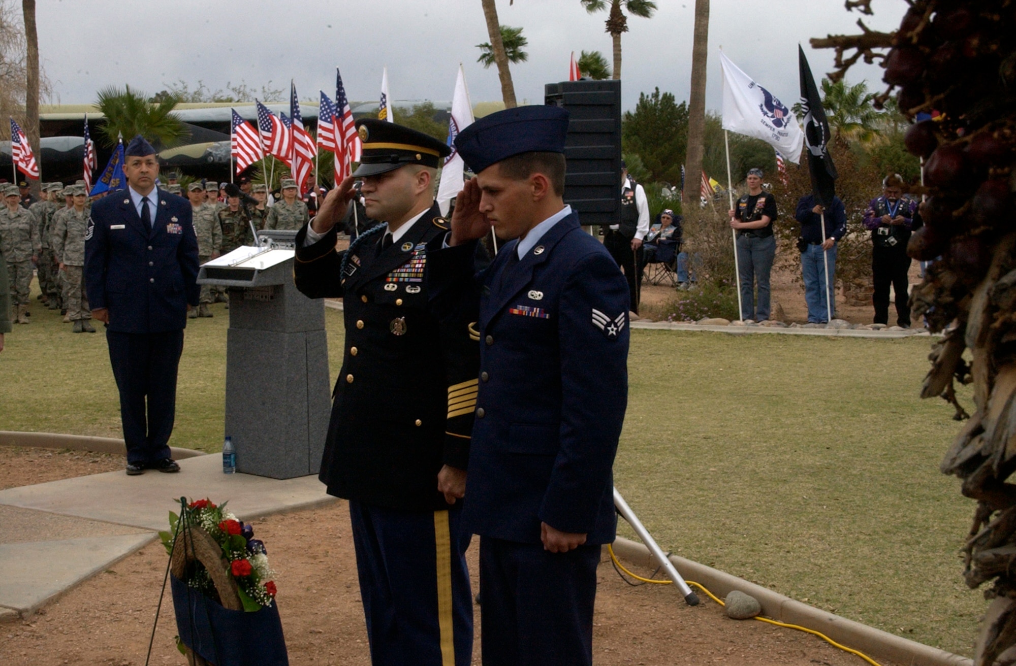 DAVIS-MONTHAN AIR FORCE BASE, Ariz. -- Army Sergeant 1st Class Derek Dutcher, a recruiter from the Tucson Recruiting Company, Center Pointe Recruiting Station, and Air Force Reserve Senior Airman David Brydon, a HH-60G Crew Chief with the 943rd Maintenance Squadron, salute in respect after placing a wreath in place at the static display model of PONY 1-2, located at Heritage Park here March 8. Four aircrew members from the 71st Specia Operations Squadron and 11 U.S. Army Special Forces Soldiers died when PONY 1-2 crashed about 20 miles northwest of Davis-Monthan Air Force Base during a nighttime training mission March 12, 1989. U.S. Air Force photo/Master Sgt. Bryan Ripple                      