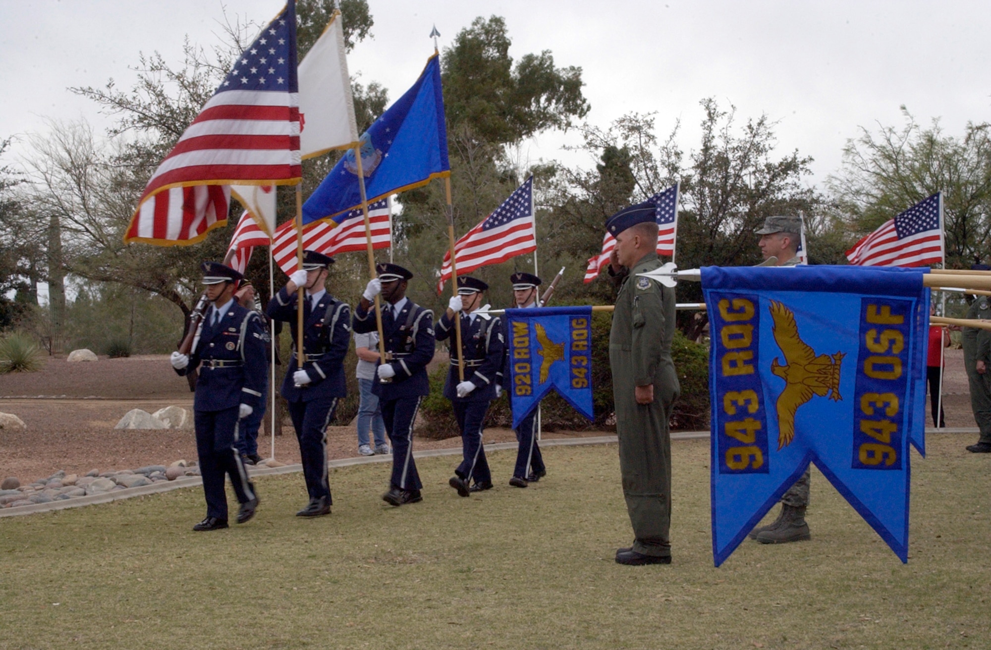 DAVIS-MONTHAN AIR FORCE BASE, Ariz. -- The Davis-Monthan Air Force Base Honor Guard marches past a formation of Air Force Reservists from the 943rd Rescue Group to post the Colors at a memorial ceremony in honor of the 15 men who died in the crash of PONY 1-2 March 12, 1989. The event was held at a static display model of the helicopter at Heritage Park here. U.S. Air Force photo/Master Sgt. Bryan Ripple    