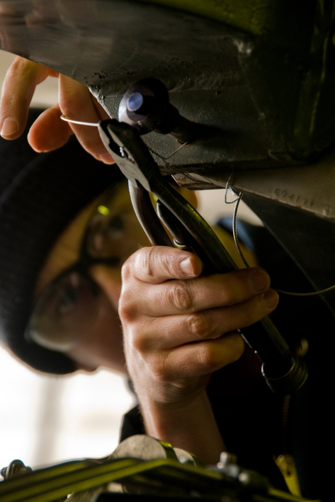 MISAWA AIR BASE, Japan -- Staff Sgt. Bryan Blumenkrantz, 35th Maintenance Squardon aerospace-propulsion journeyman, removes saftey pins from an F110-GE-129 engine March 3, 2009. Safety pins installed during shipping were removed before the engine was tested. (U.S. Air Force photo by Senior Airman Jamal D. Sutter)