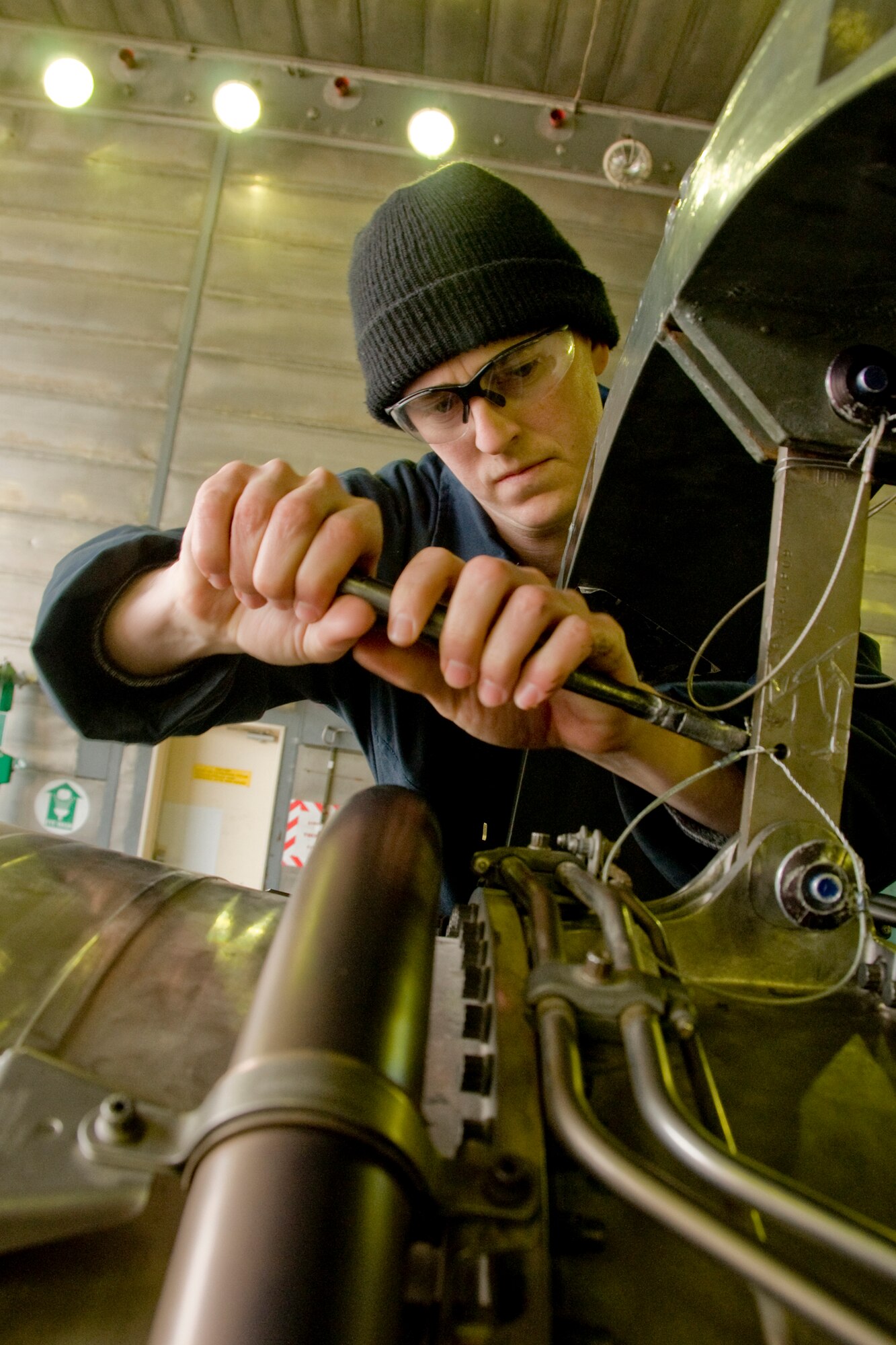 MISAWA AIR BASE, Japan -- Senior Airman Bryan Blumenkrantz, 35th Maintenance Squardon aerospace-propulsion journeyman, removes saftey pins from an F110-GE-129 engine March 3, 2009. Airman Blumenkrantz, a staff sergeant select, was also recently accepted to officer training school. (U.S. Air Force photo by Senior Airman Jamal D. Sutter)